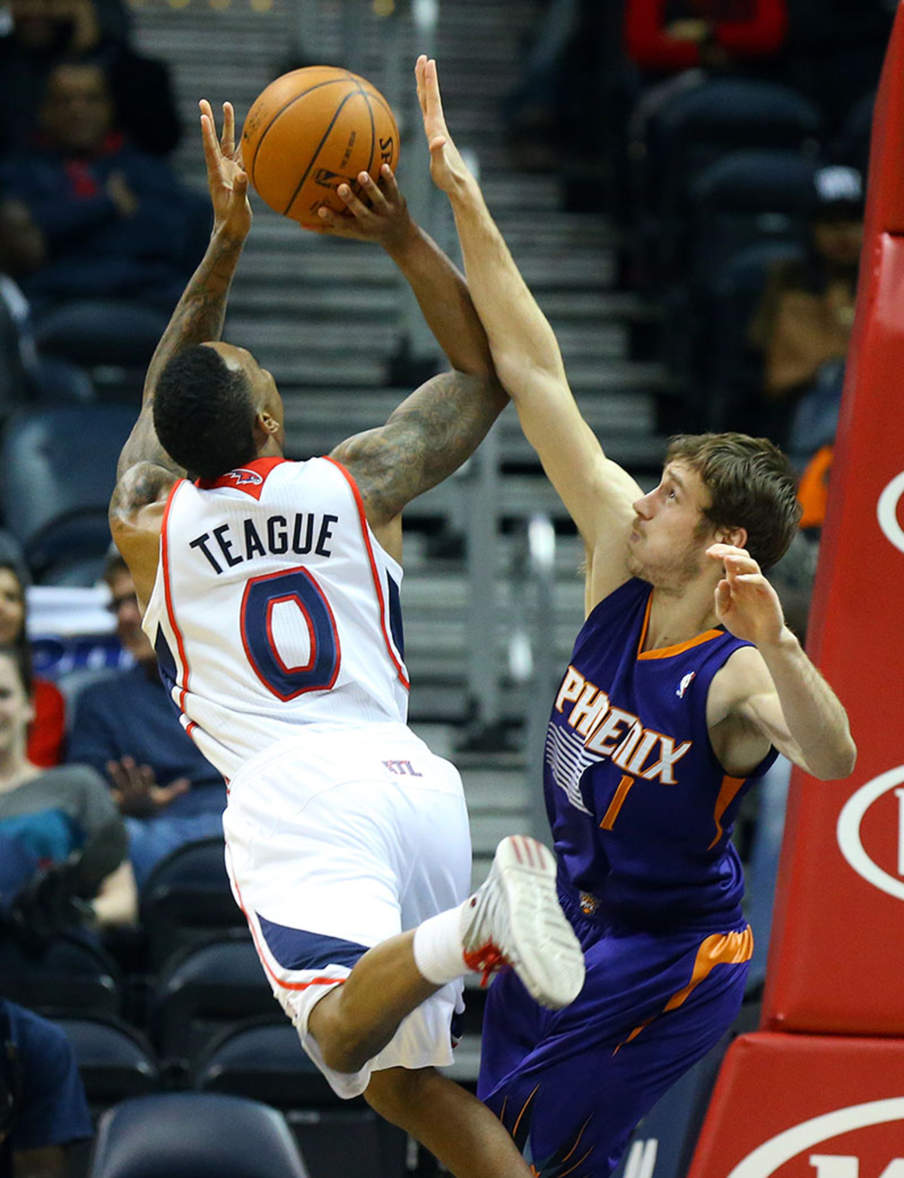 Suns guard Goran Dragic blocks a shot by Hawks guard Jeff Teague. Teague had 17 points in the 102-95 loss.