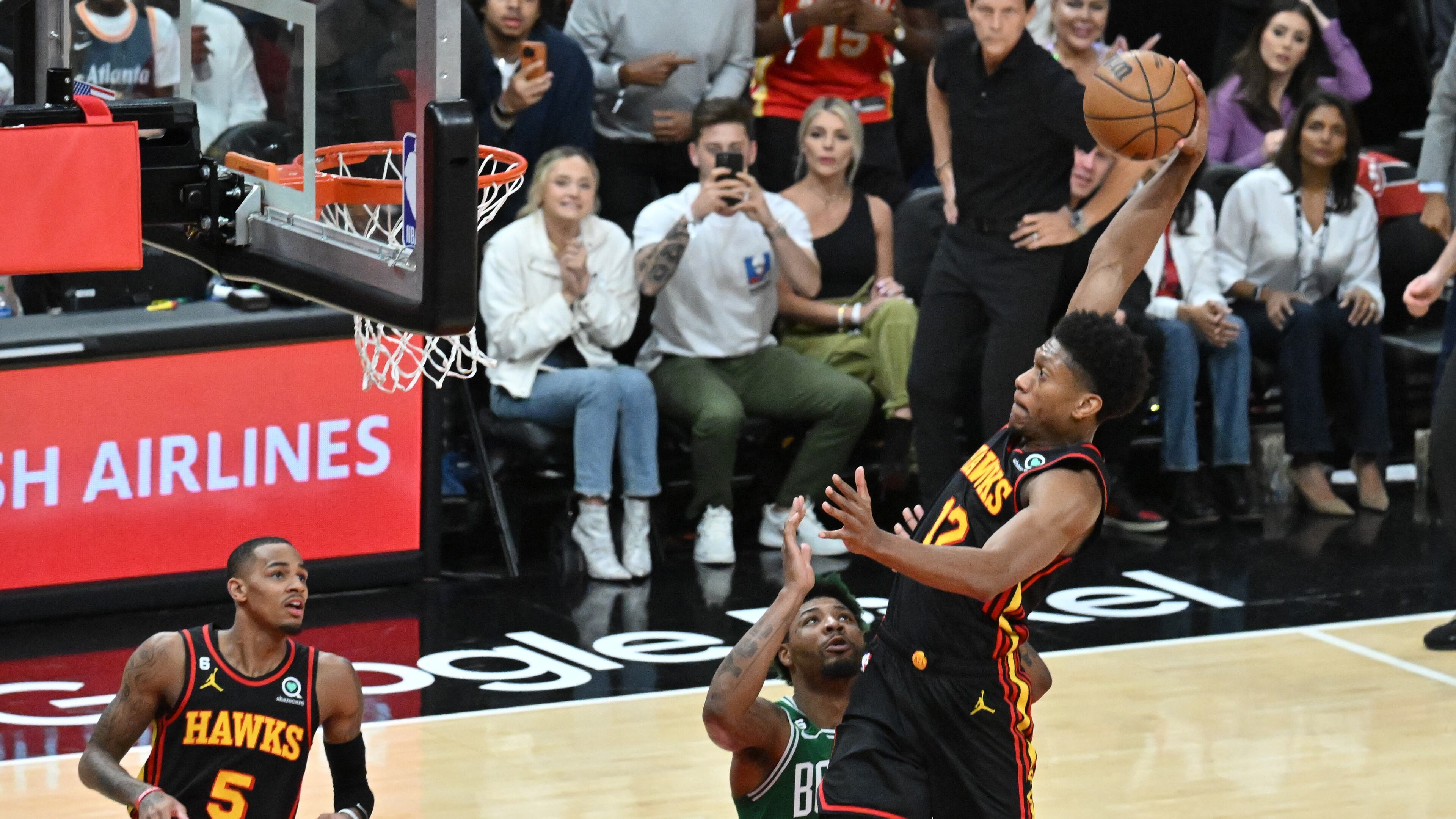 Hawks forward De'Andre Hunter (12) dunks against the Boston Celtics during the first half in Game 4 of the first round of the Eastern Conference playoffs at State Farm Arena, Sunday, April 23, 2023, in Atlanta.