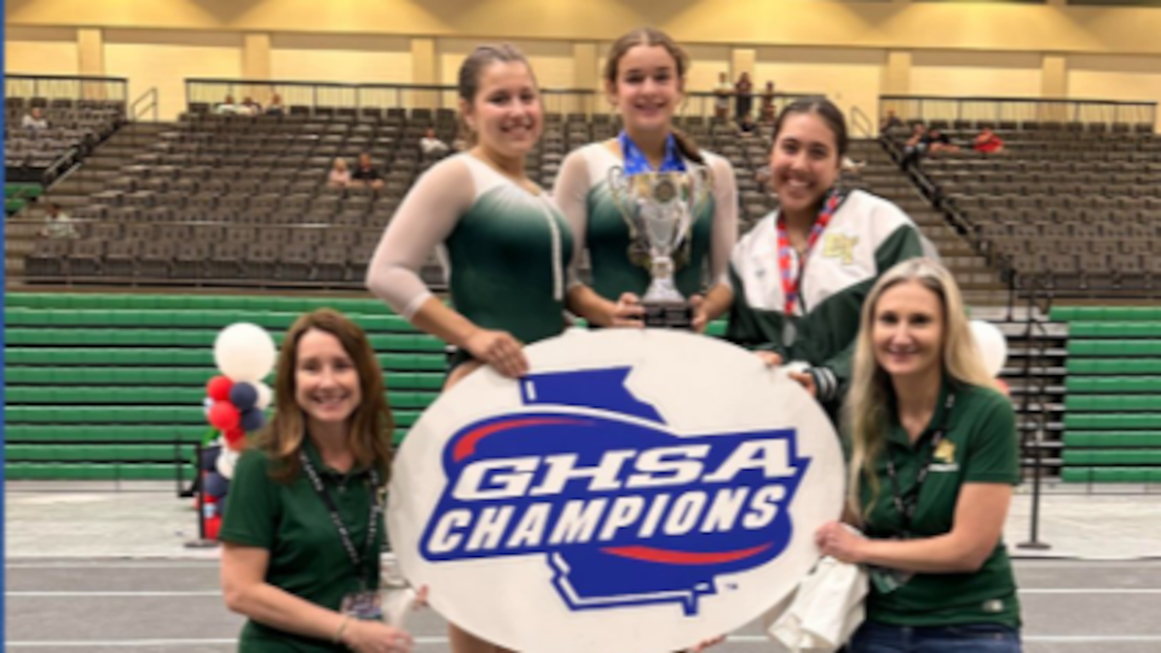 Blessed Trinity started its first gymnastics team this season. The Titans — made up of coach Bethany Cotter (from left), Chloe Seng, Gabriella Perez, Isabella Sutapaha and coach Nicole Irvin — won their first state championship on Friday, April 24, 2026. (Courtesy of the Georgia High School Association)
