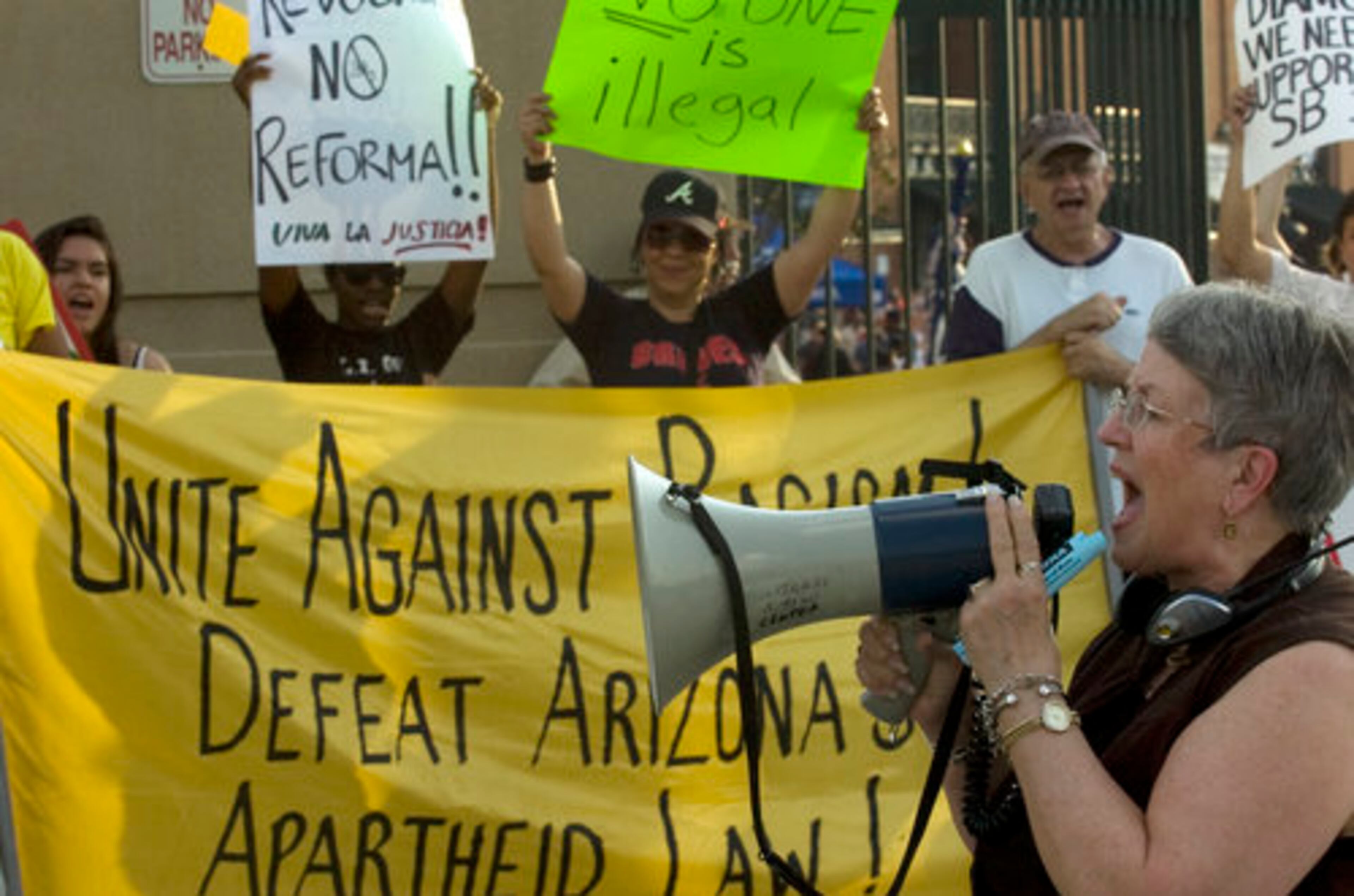 At Turner Field on Saturday evening, State Sen. Nan Orrock speaks to a group of more than fifty people protesting Arizona's recent immigration law giving police much broader powers to detain people suspected of being in the state illegally.
