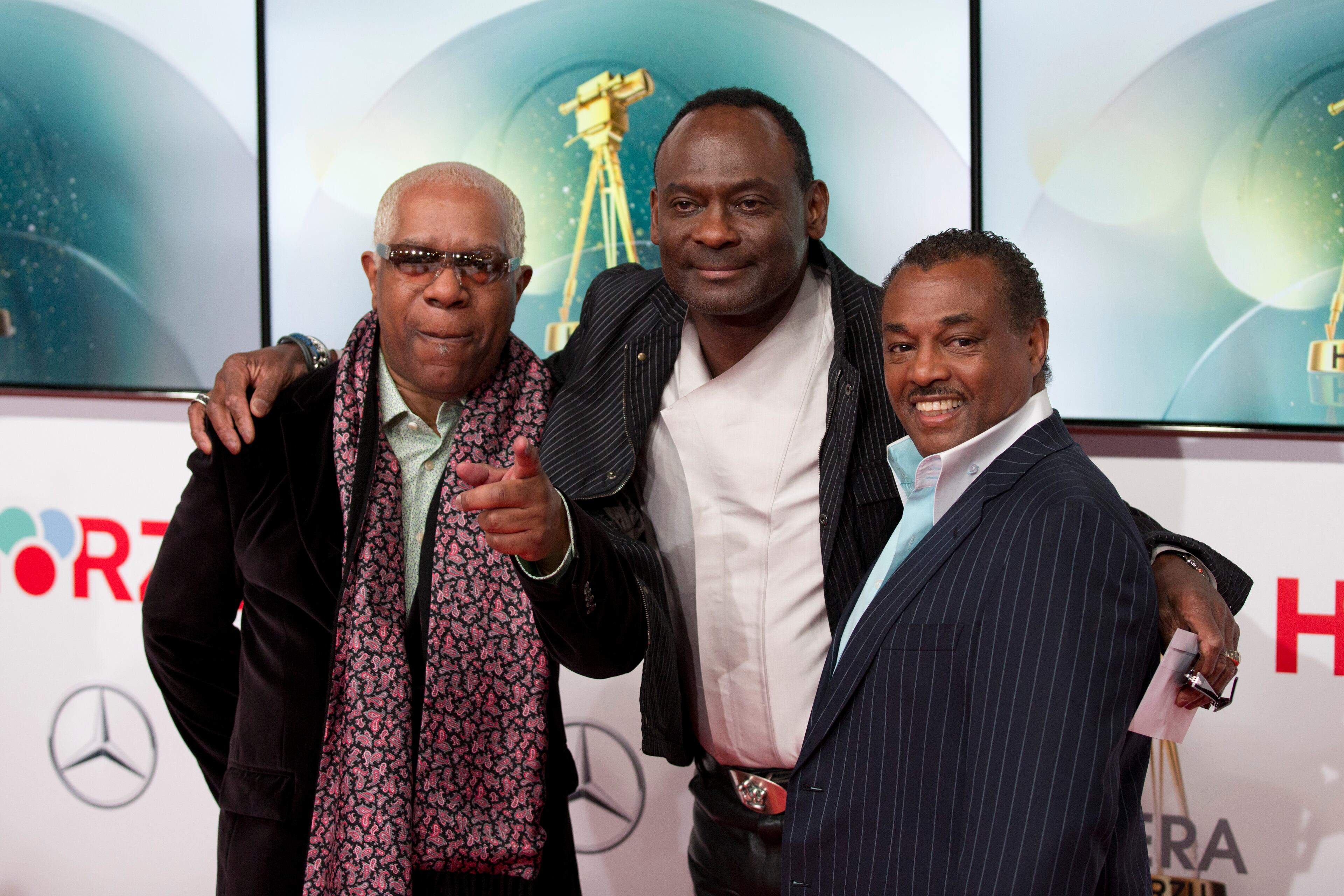 Members of the band Kool & the Gang, from left, Larry Marano, Ronald Bell and Robert Bell arrive on the red carpet for the Goldene Kamera (Golden Camera) media awards in Berlin, Germany, Saturday, Feb. 1, 2014. (AP Photo/Axel Schmidt)