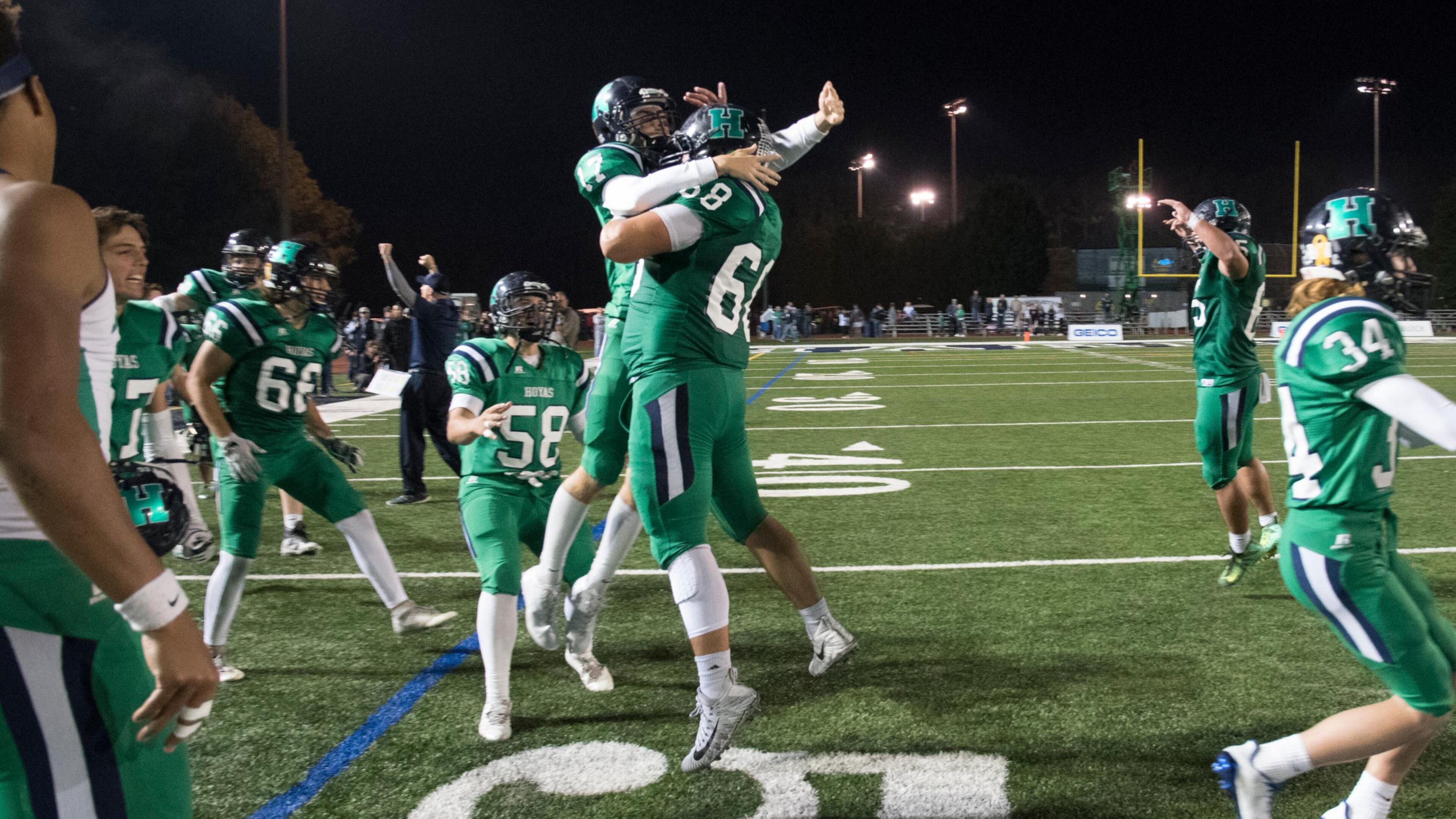 dHarrison's Cooper Guilotte (17) and Andrew Waller (68) celebrate after winning 28-26 during a high school football game against Dalton on Thursday, Oct. 19, 2017, in Kennesaw, Ga. (Special to the Atlanta Journal-Constitution, John Amis )