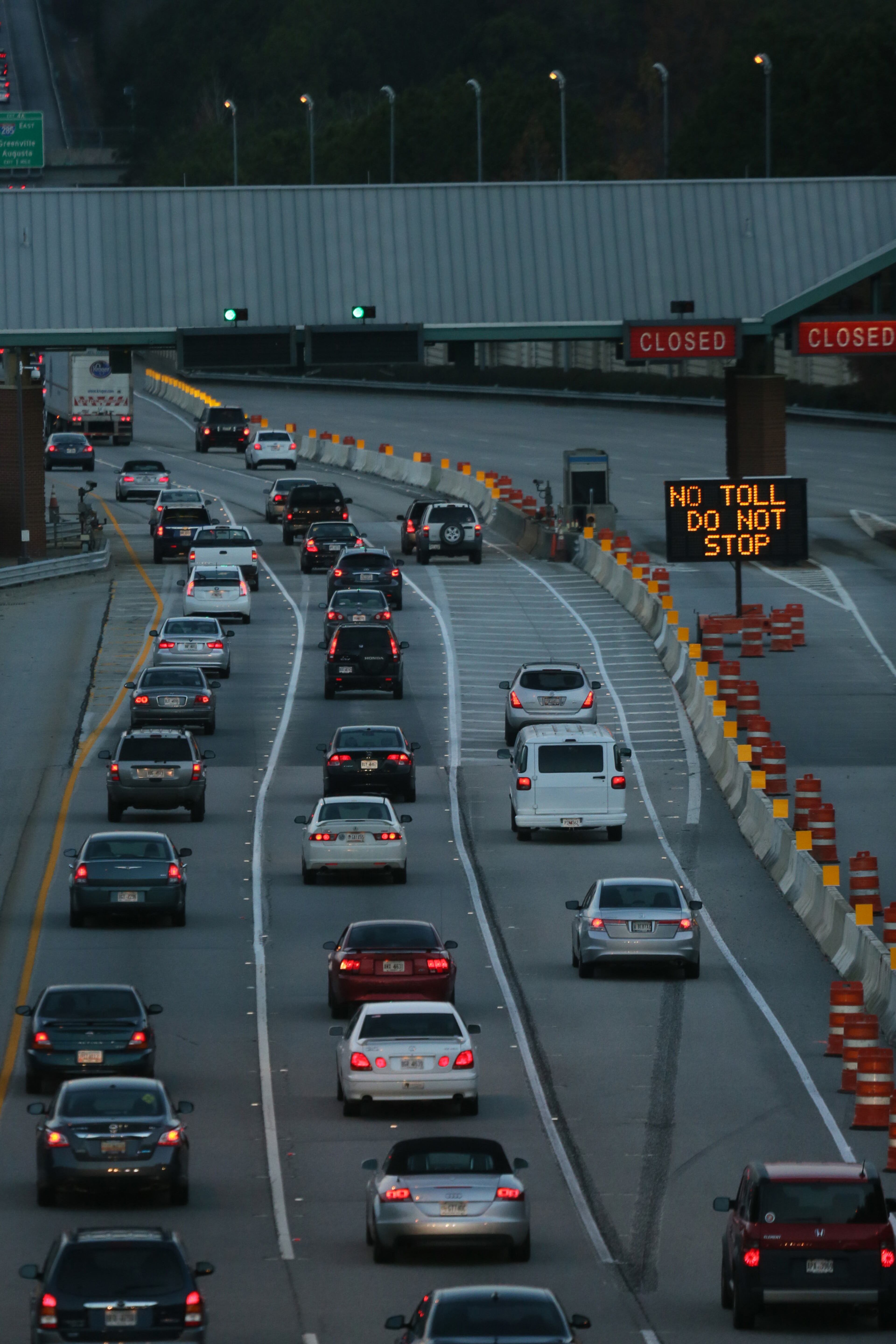 The scene at morning rush hour at the Ga 400 tolls. The tolls were closed on Friday after 20 years. Demolition of the toll will begin in January. Drivers can now use three lanes in each direction for free. However, the speed limit will be reduced to 45 mph through the construction zone while the work is in progress, and traffic will be rerouted through the Cruise Card lanes. BOB ANDRES/BANDRES@AJC.COM