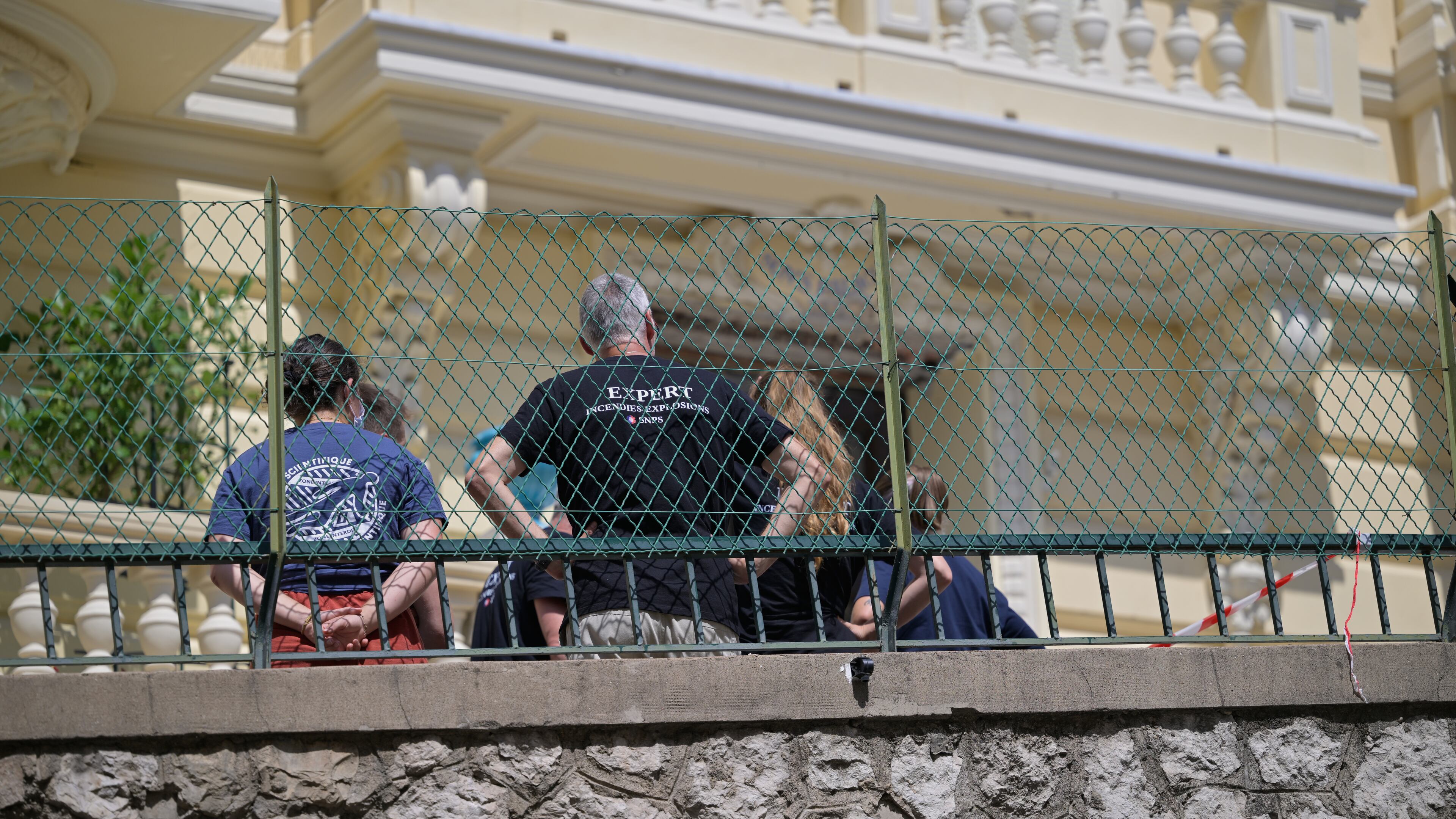 Investigators examine the scene at the residential building where an explosive device seriously injured three people a day earlier in Monaco, Tuesday, June 30, 2026. (AP Photo/Philippe Magoni)
