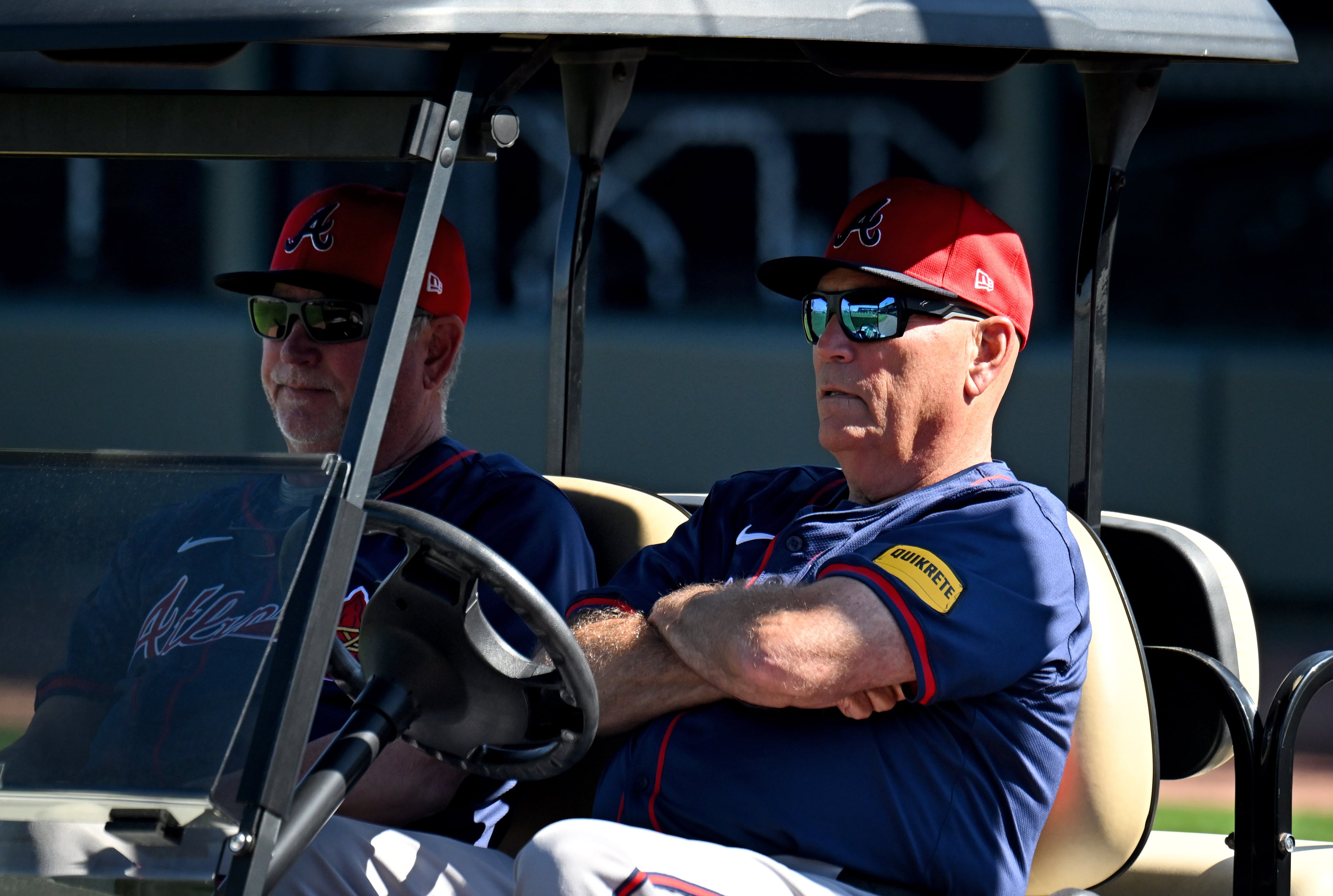 Braves manager Brian Snitker (right) and coach Greg Walker watch from the golf cart during spring training baseball workouts at CoolToday Park, Thursday, February, 15, 2024, in North Port, Florida. (Hyosub Shin / Hyosub.Shin@ajc.com)