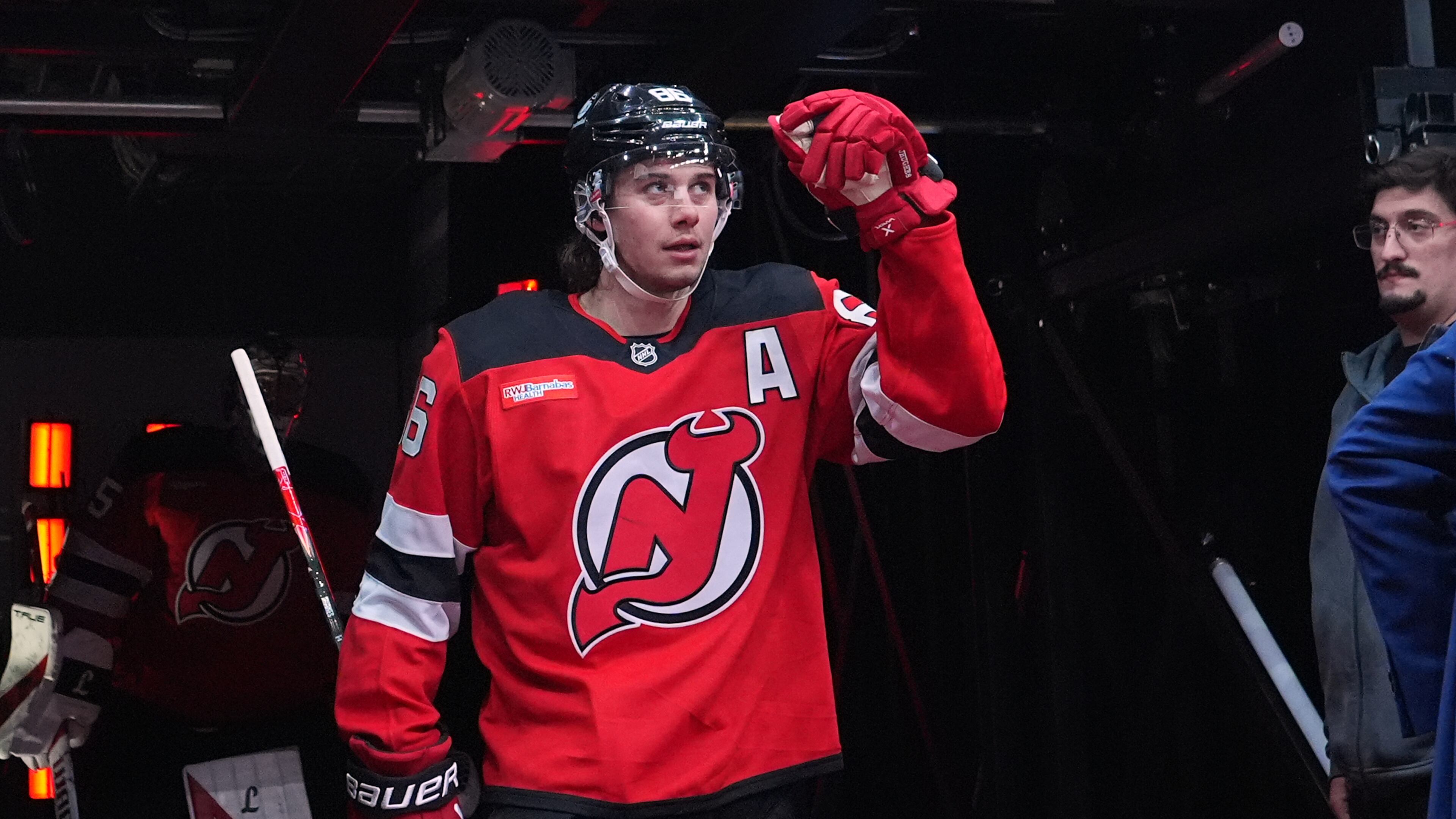 New Jersey Devils' Jack Hughes (86) walks toward the ice to warm up before an NHL hockey game against the Buffalo Sabres Wednesday, Feb. 25, 2026, in Newark, N.J. (AP Photo/Frank Franklin II)