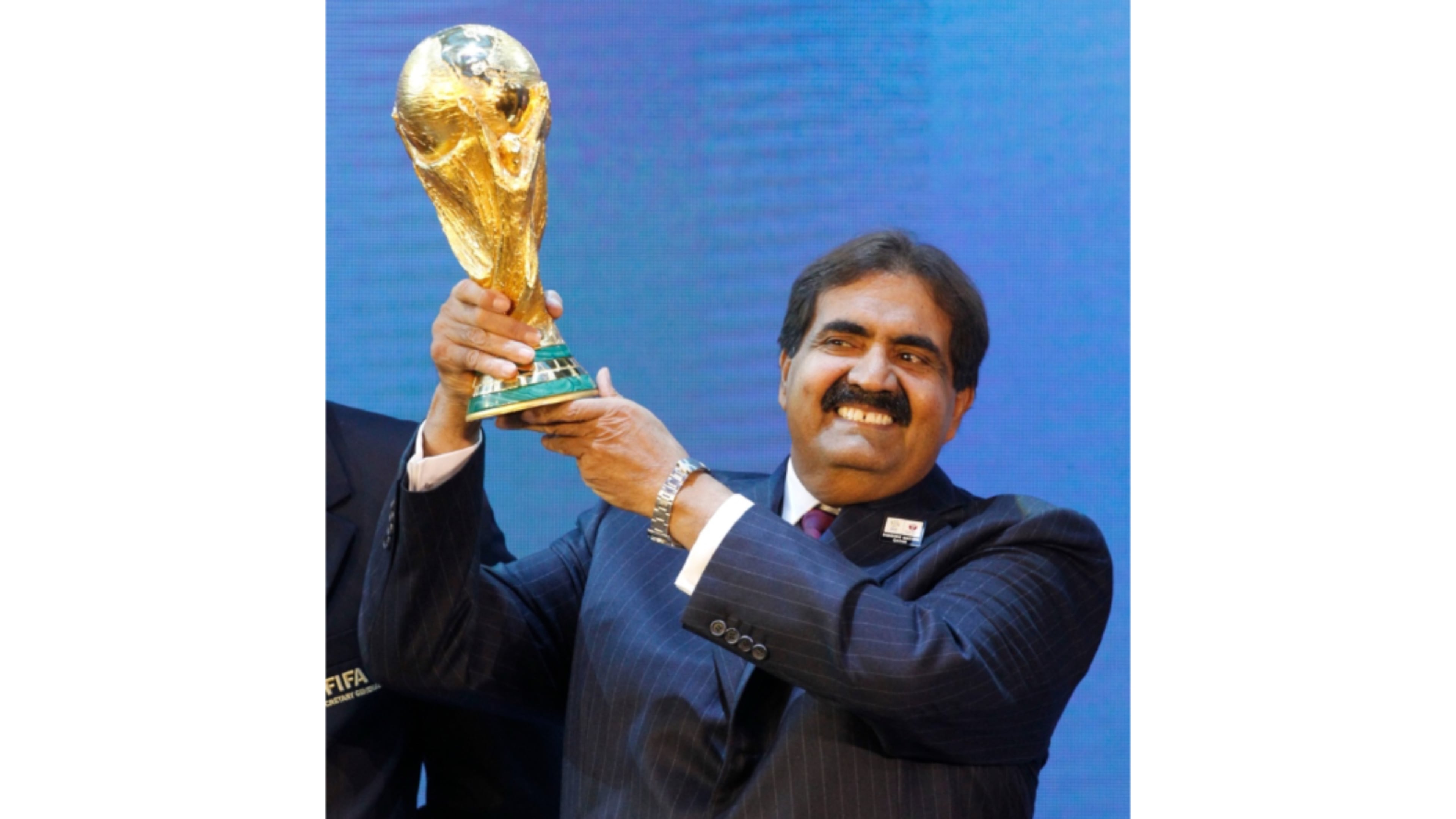 FILE - Sheikh Hamad bin Khalifa Al Thani, Emir of Qatar, holds the World Cup trophy after the announcement of Qatar hosting the 2022 soccer World Cup in Zurich, Switzerland, Dec. 2, 2010. (AP Photo/Anja Niedringhaus, File)