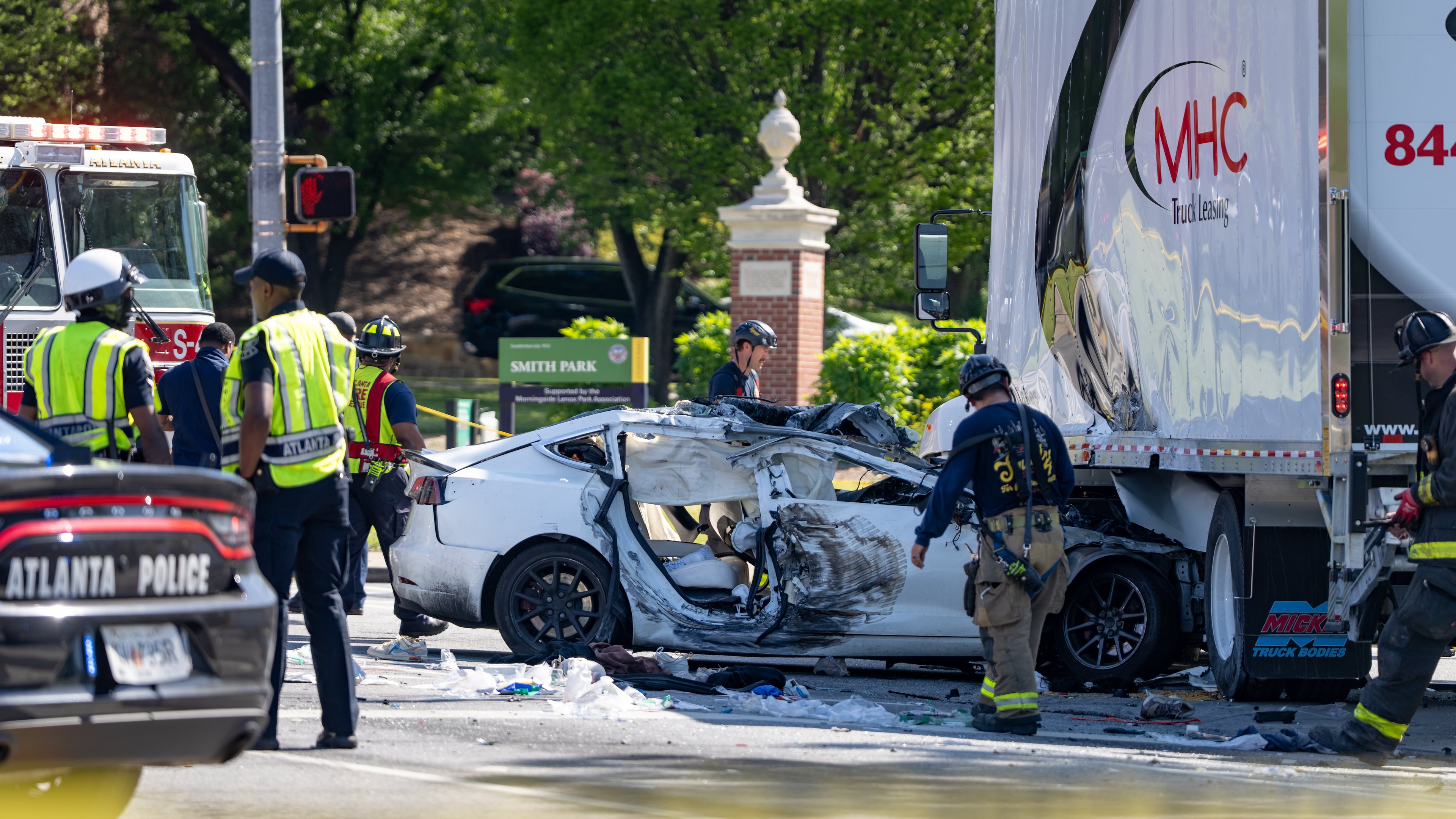 Atlanta firefighters work at the scene of a fatal crash on Piedmont Avenue at Monroe Drive in April. There were 425 traffic-related deaths last year in Clayton, Cobb, DeKalb, Fulton and Gwinnett counties. (Ben Hendren for the Atlanta Journal-Constitution)