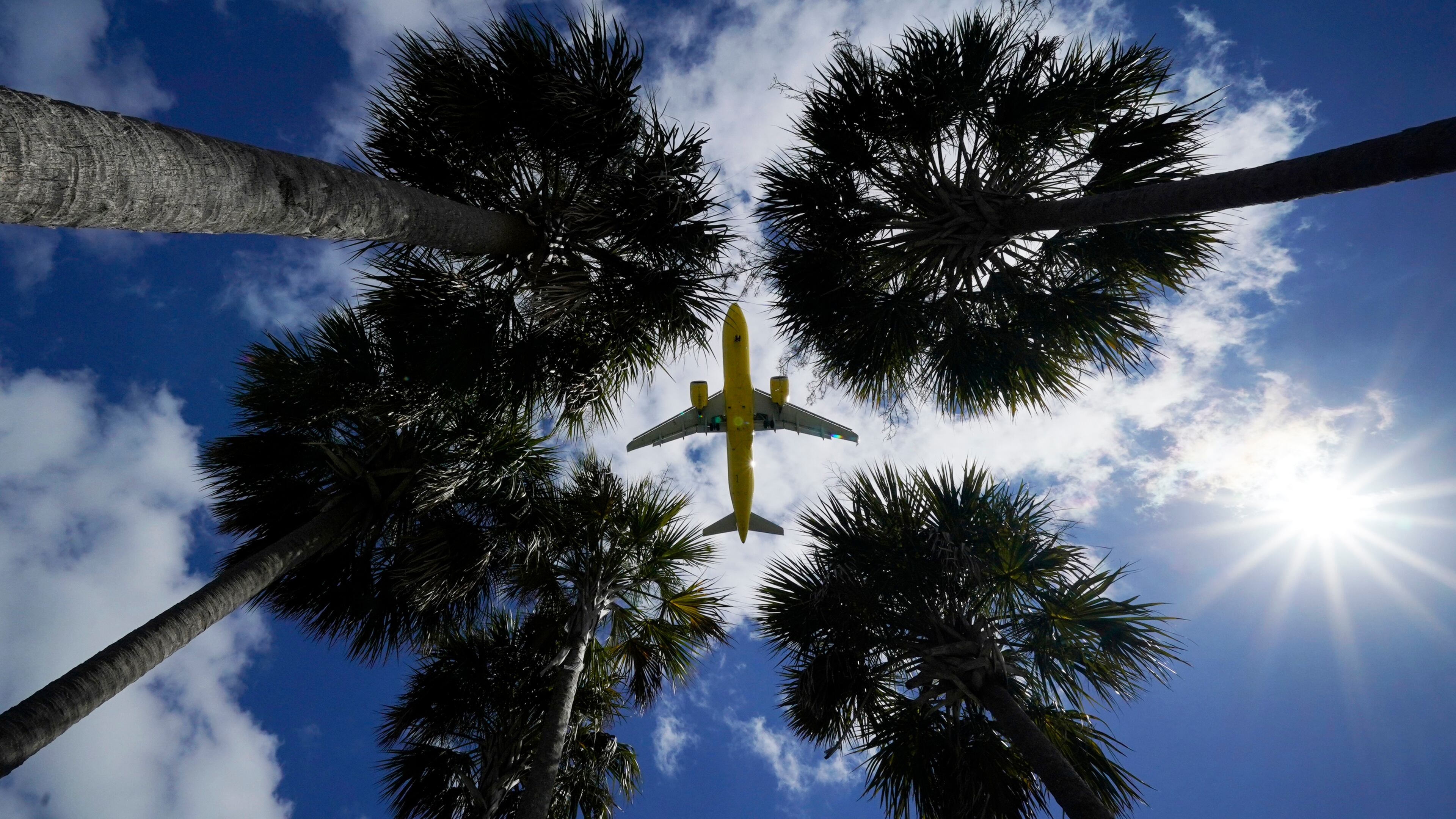 FILE - In this Friday, March 19, 2021 file photo, an airliner lands at Tampa International Airport in Tampa, Fla. On Sunday, March 21, more than 1.5 million people streamed through U.S. airport security checkpoints, the largest number since the pandemic tightened its grip on the United States more than a year ago. However, passenger traffic remains far below 2019 levels. (AP Photo/Gene J. Puskar)