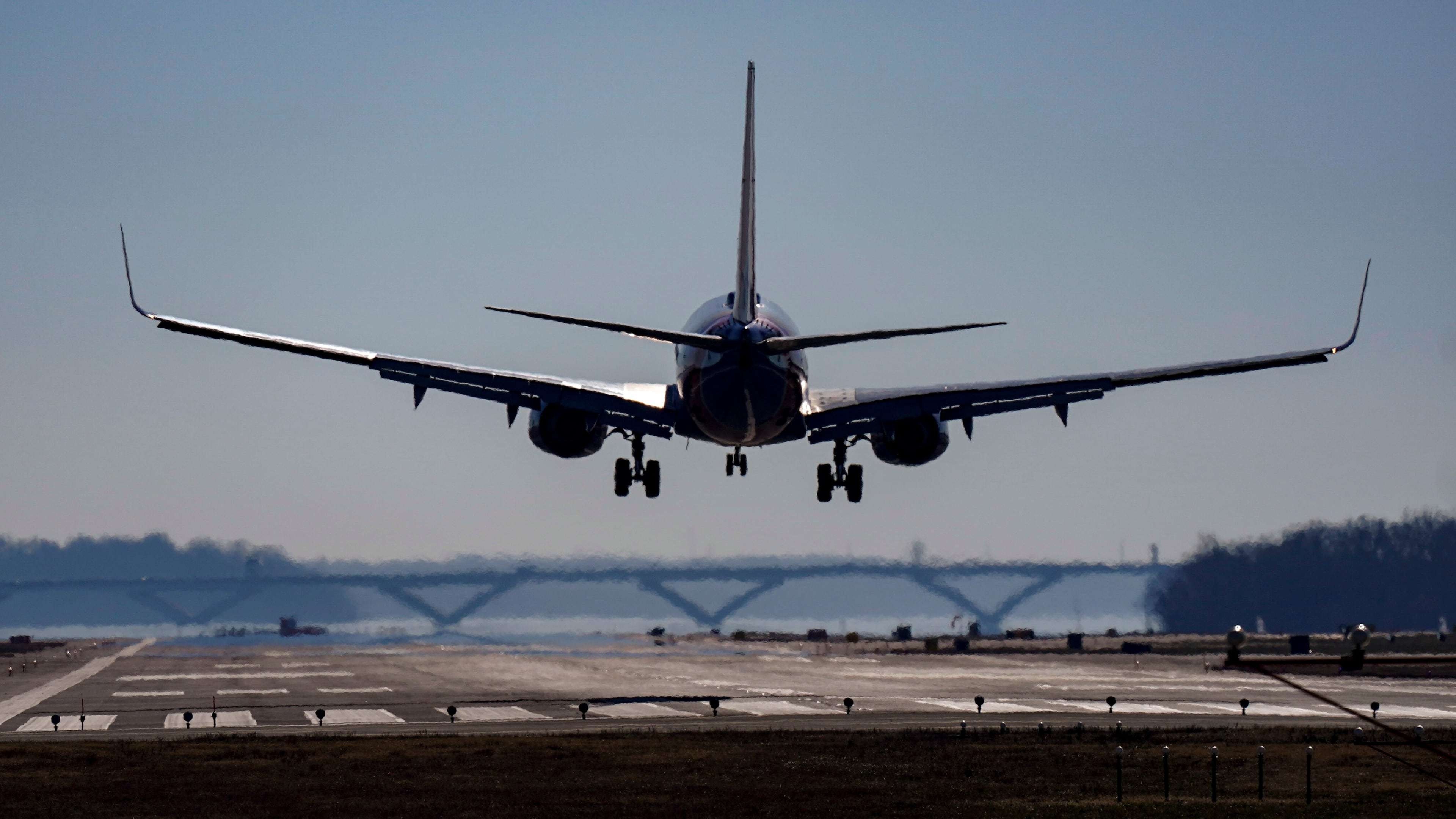 FILE - A plane lands at Ronald Reagan Washington National Airport in Arlington, Va., Dec. 30, 2022. (AP Photo/Carolyn Kaster, File)