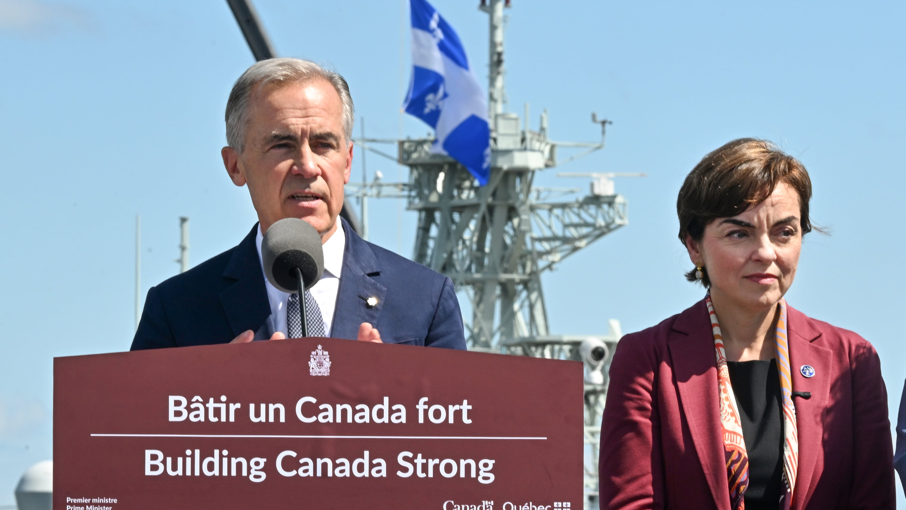 Canadian Prime Minister Mark Carney speaks as he announces a $11.3 billion contract for icebreakers at the Davie shipyard in Levis, Quebec on Monday, Aug. 24, 2026. Quebec Premier Christine Frechette, right, looks on. (Jacques Boissinot/The Canadian Press via AP)