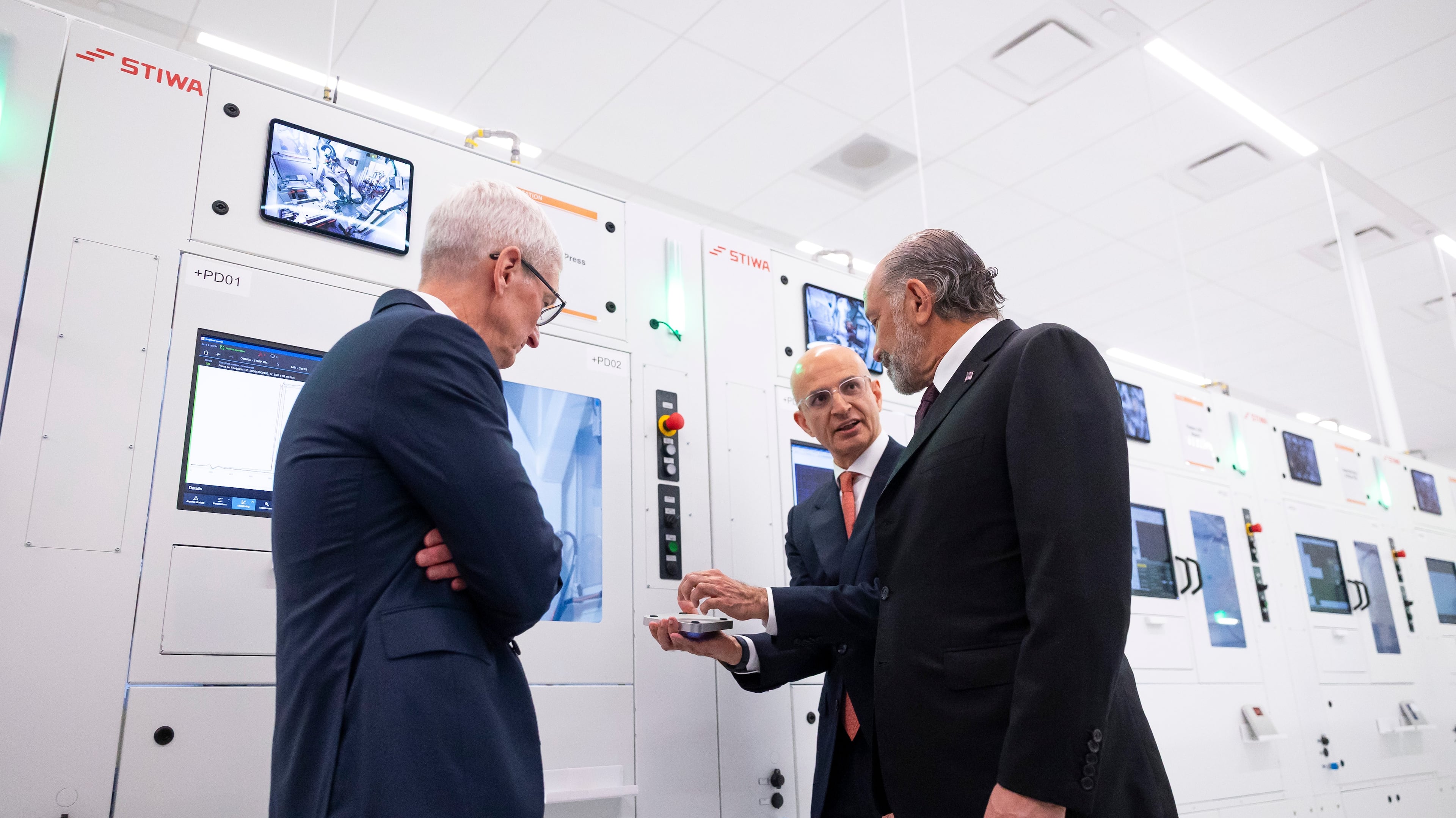 Apple COO Sabih Khan, center, and CEO Tim Cook, left, give U.S. Secretary of Commerce Howard Lutnick a tour of a learning lab at Apple's Advanced Manufacturing Center in Houston, Thursday, Aug. 13, 2026. (AP Photo/Annie Mulligan)