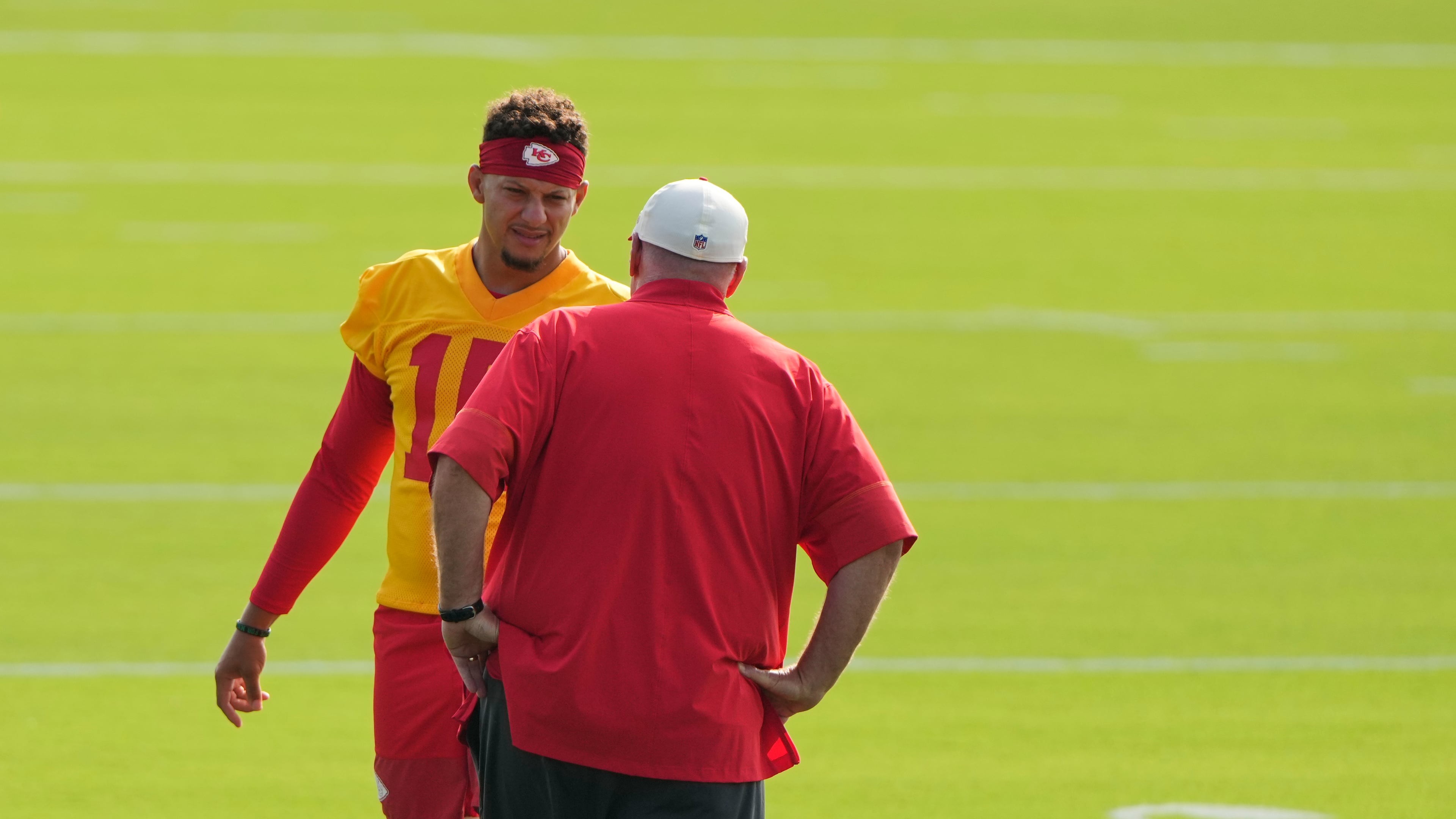 Kansas City Chiefs quarterback Patrick Mahomes talks with head coach Andy Reid at NFL football training camp Saturday, July 25, 2026, in St. Joseph, Mo. (AP Photo/Charlie Riedel)