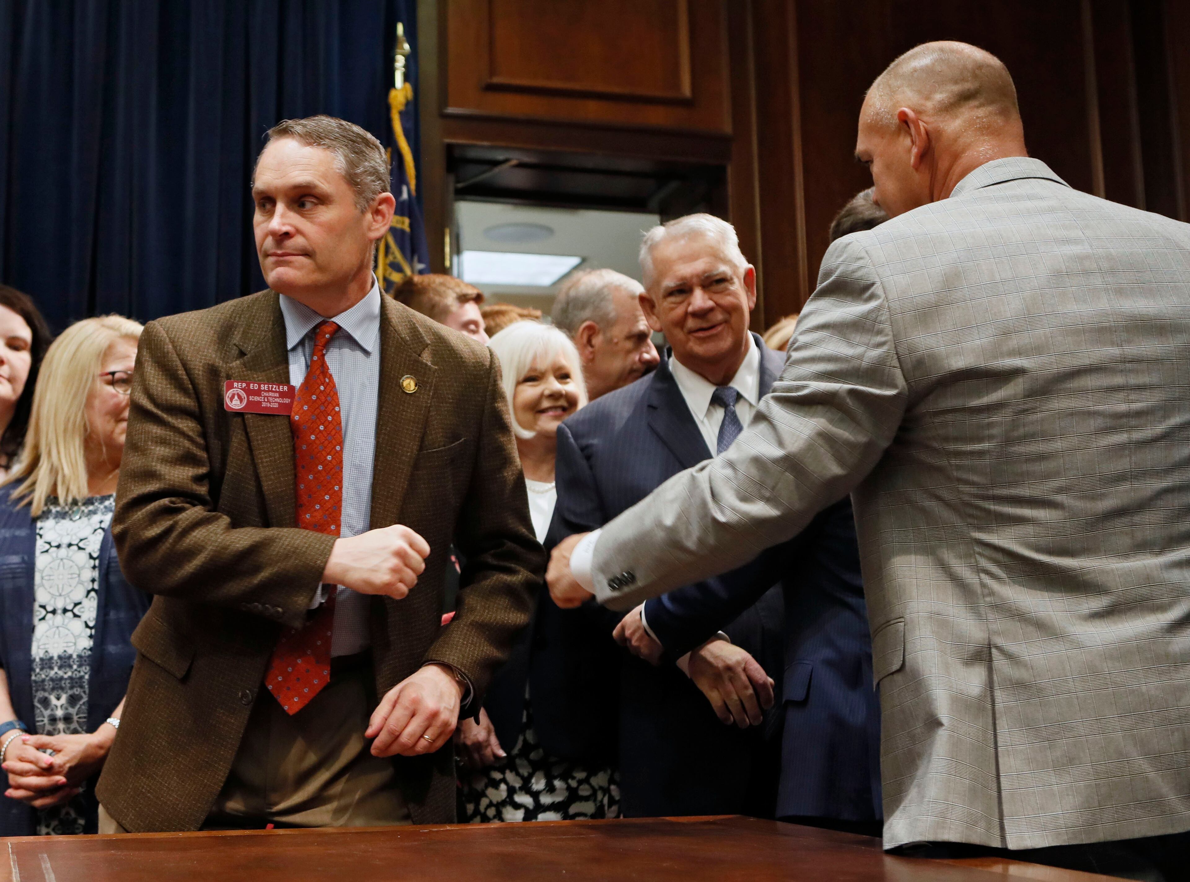 May 7, 2019 - Atlanta - Sen. Bruce Thompson (right), R - White, gives Rep. Ed Setzler, R - Acworth, a fist bump before the signing. Surrounded by supporters of the bill, Gov. Brian Kemp signed HB 481, the "heartbeat bill", on Tuesday, setting the stage for a legal battle as the state attempts to outlaw most abortions after about six weeks of pregnancy. The bill, sponsored by Rep. Ed Setlzer, R-Acworth, and carried in the Senate by Sen. Renee Unterman, R - Buford, outlaws most abortions once a doctor can detect a fetus' heartbeat - usually around six weeks of pregnancy. Bob Andres / bandres@ajc.com