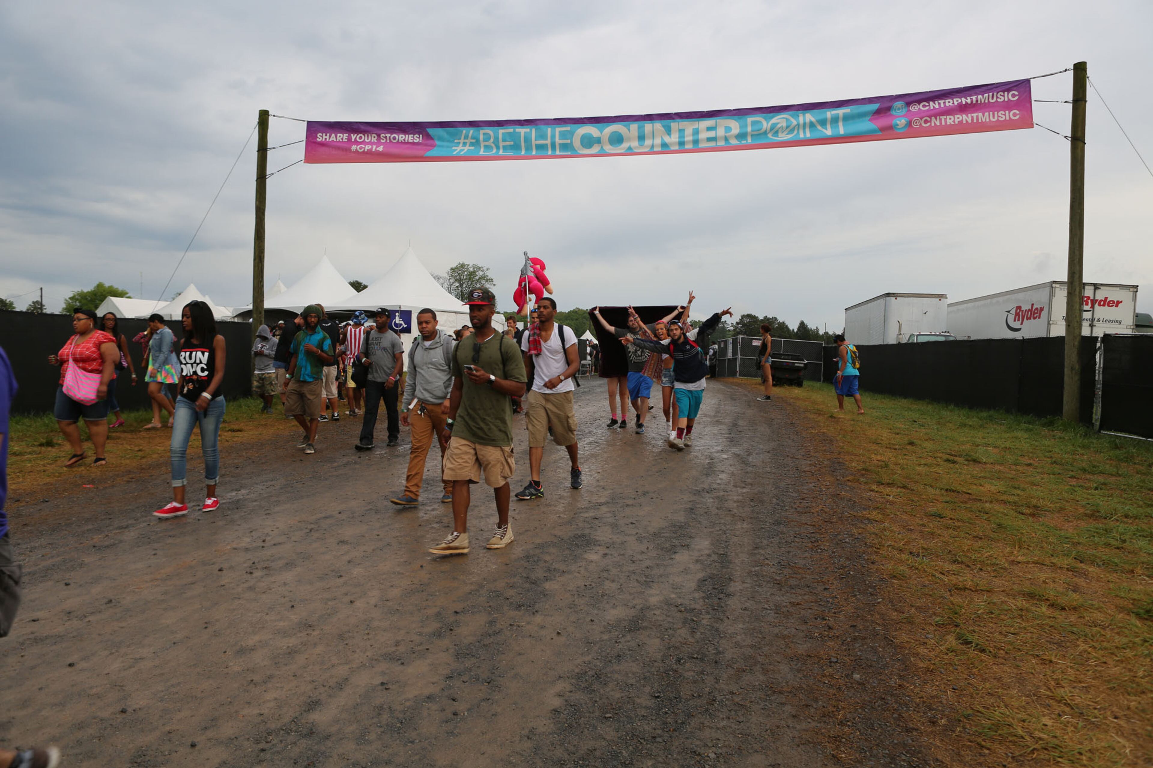 Concert-goers celebrate being able to return to the Counterpoint Music & Arts Festival at Kingston Downs after an electrical storm Sunday. (Akili-Casundria Ramsess/Special to the AJC)