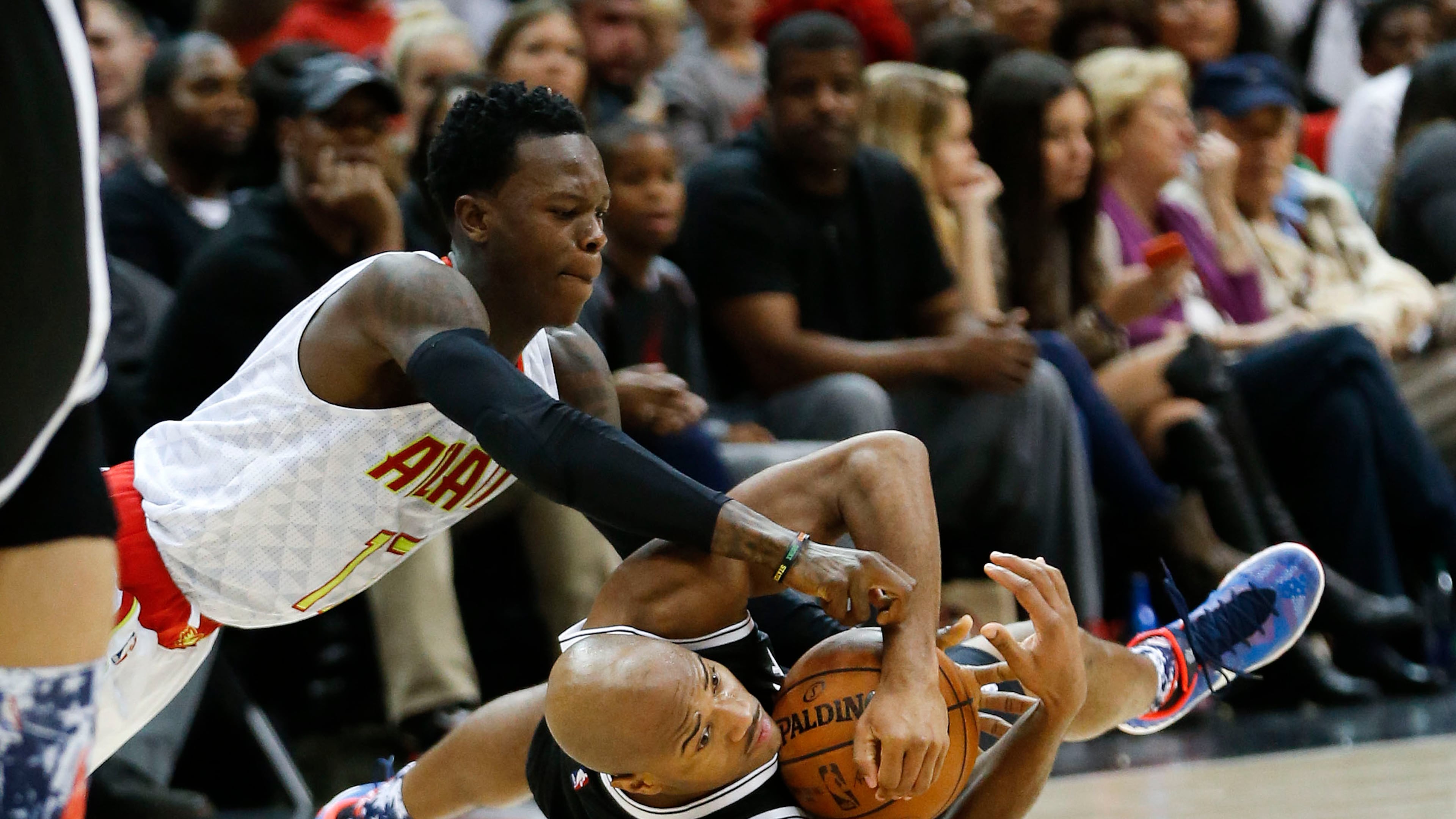 Brooklyn Nets guard Jarrett Jack (2) and Atlanta Hawks guard Dennis Schroder (17) scramble on the floor for the ball in the second half of an NBA basketball game Wednesday, Nov. 4, 2015, in Atlanta. Atlanta won 101-87. (AP Photo/John Bazemore)