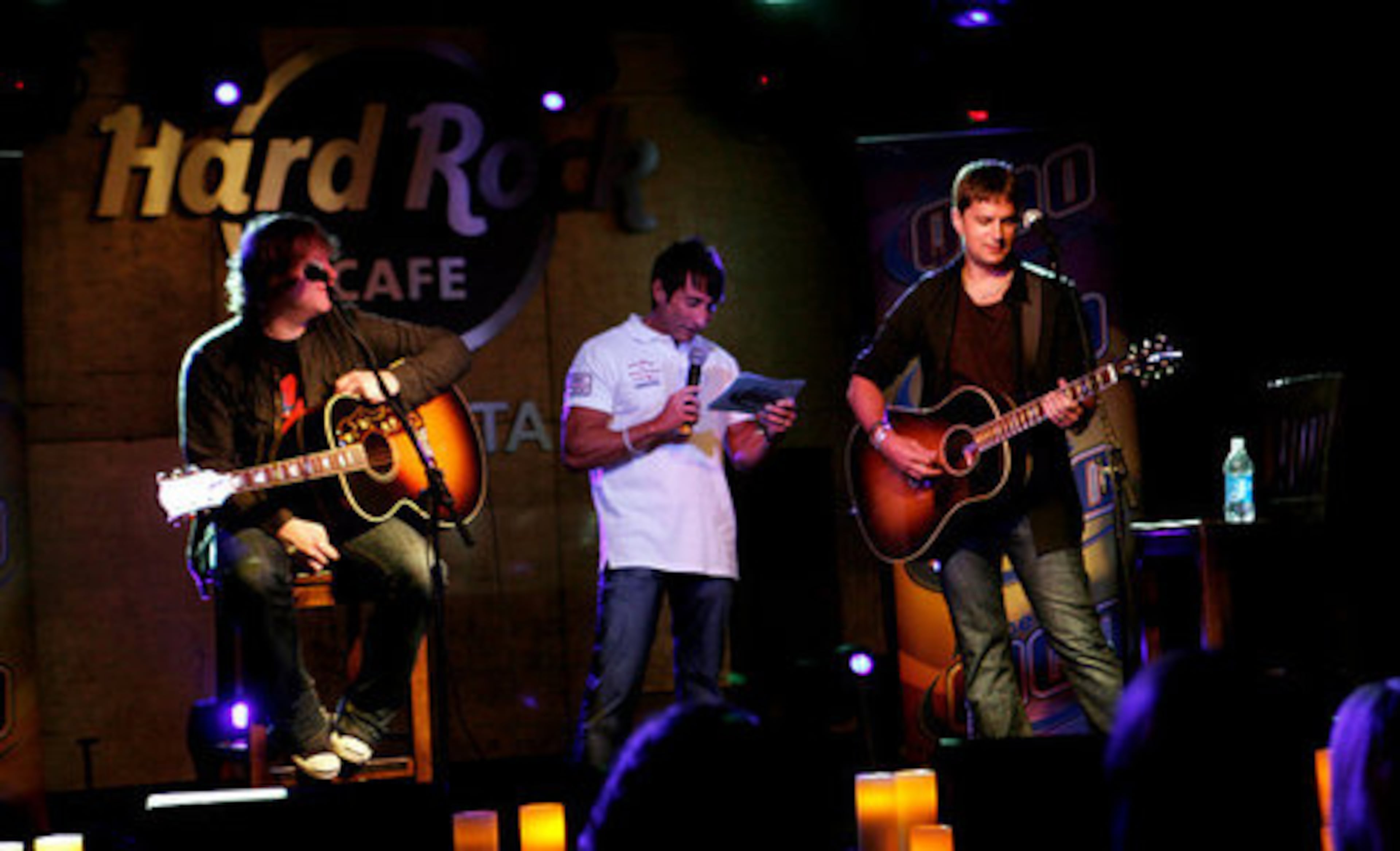 Matt Beck, left, Rob Thomas' bass guitarist takes a break at Q100's Bert Weiss interviews Thomas in 2009.