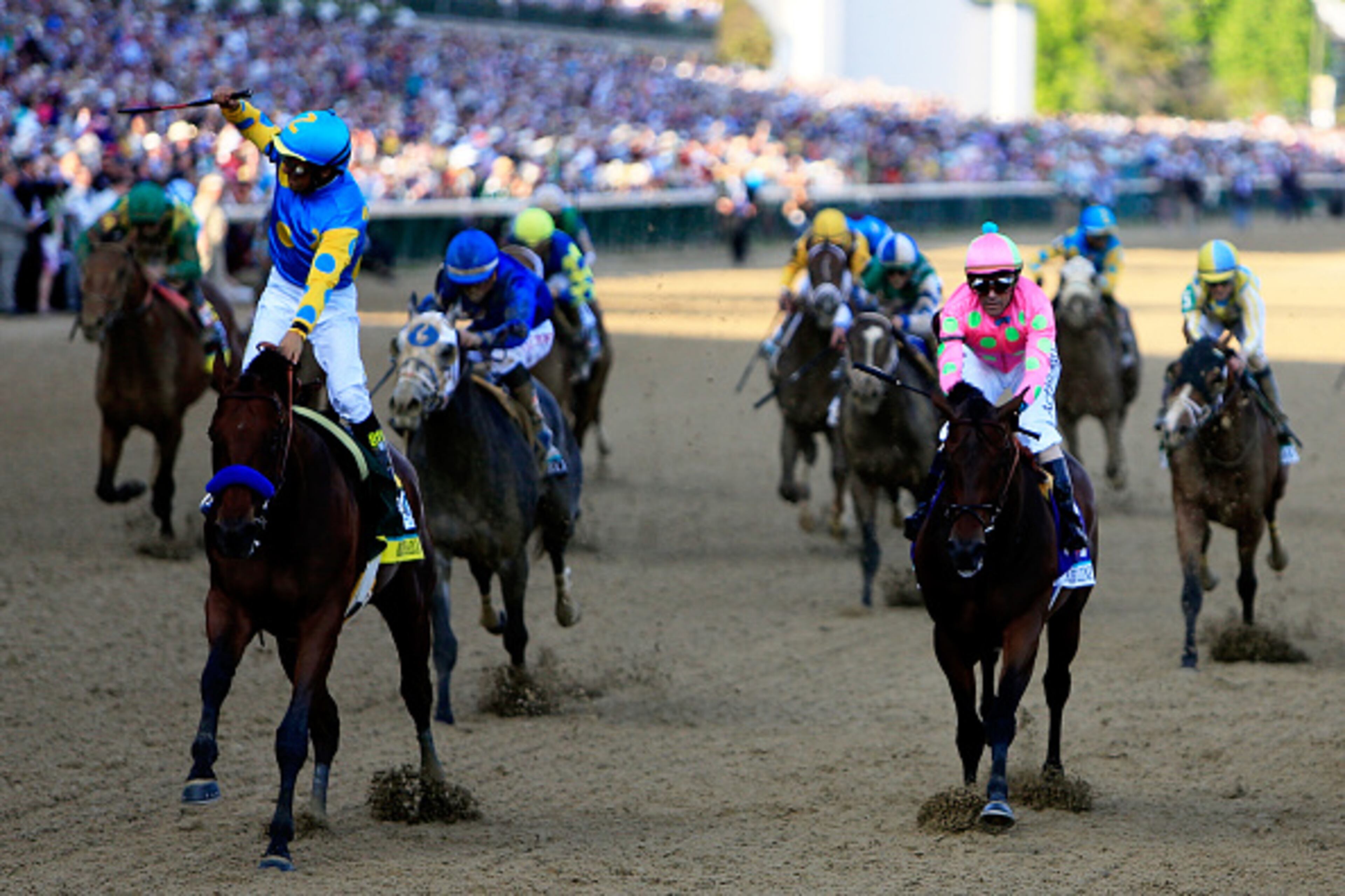 LOUISVILLE, KY - MAY 02: Jockey Victor Espinoza celebrates as he guides American Pharoah #18 after crossing the finish line to win the 141st running of the Kentucky Derby at Churchill Downs on May 2, 2015 in Louisville, Kentucky. (Photo by Rob Carr/Getty Images)