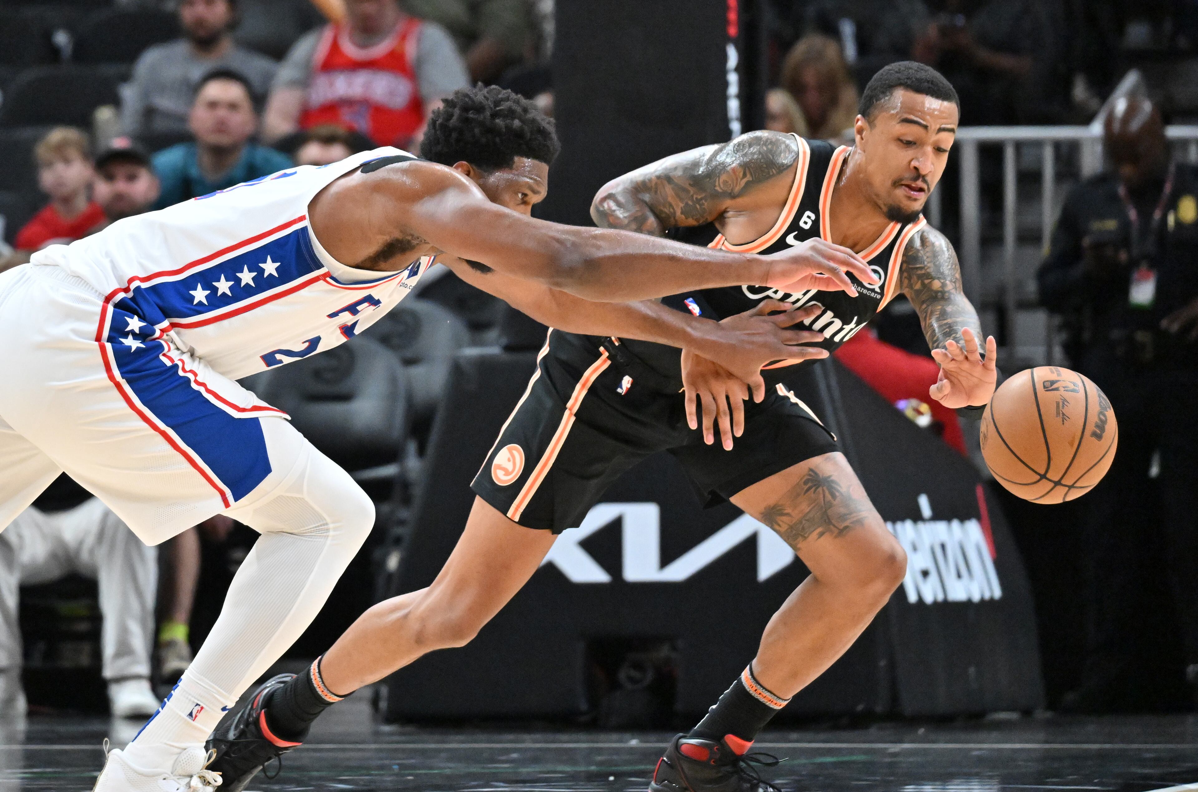 Hawks' forward John Collins (right) steals from Philadelphia 76ers' center Joel Embiid during the first half in an NBA basketball game at State Farm Arena on Thursday, November 10, 2022. (Hyosub Shin / Hyosub.Shin@ajc.com)
