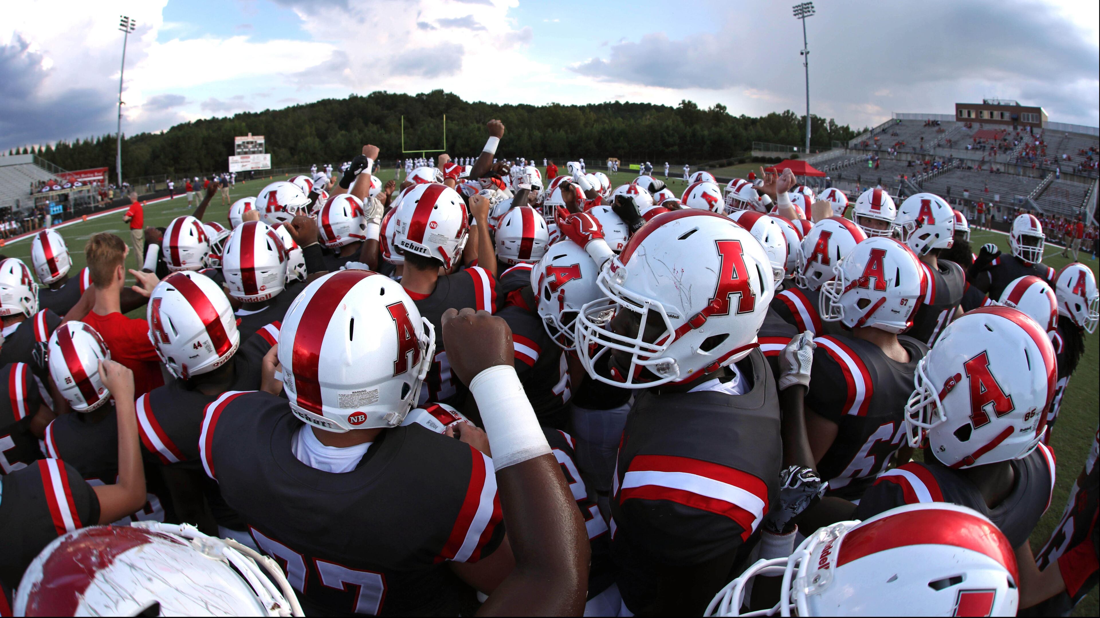 Archer players gather in a huddle before Friday's home game against Mill Creek. (Jason Getz/Special)