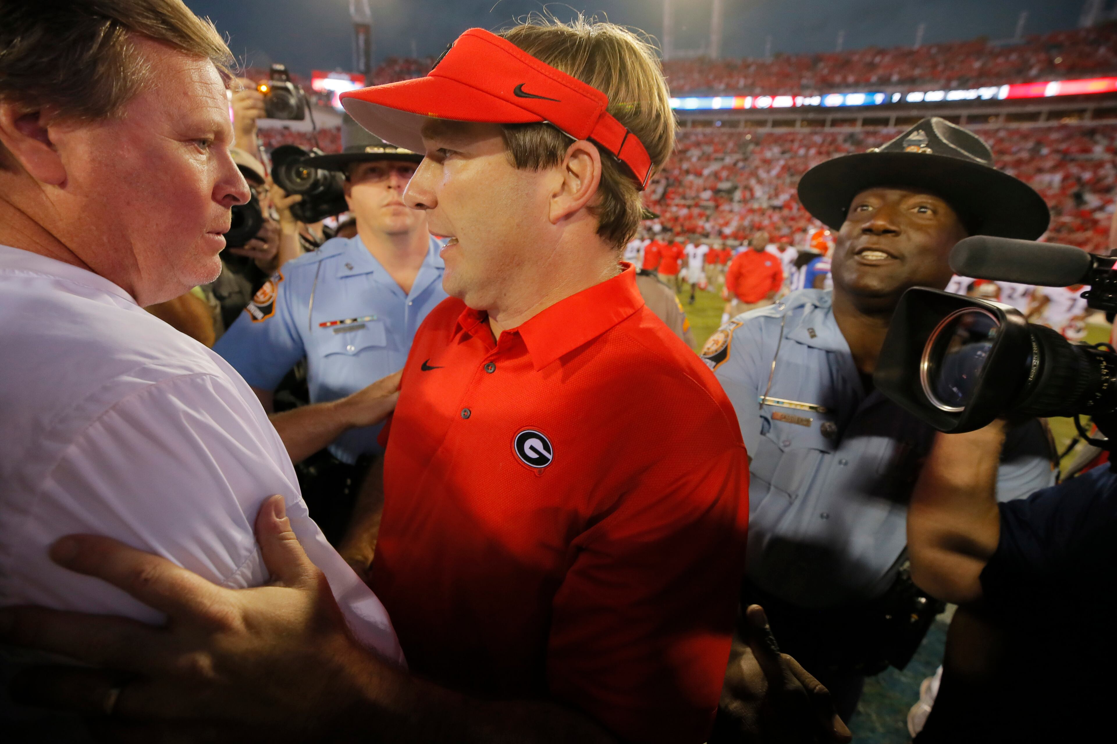 10/28/17 - Jacksonville, FL - Georgia coach Kirby Smart meets Florida coach Jim McElwain after the game. NCAA football game between Georgia and Florida at EverBank Field in Jacksonville. Georgia defeated Florida 42-7. BOB ANDRES /BANDRES@AJC.COM