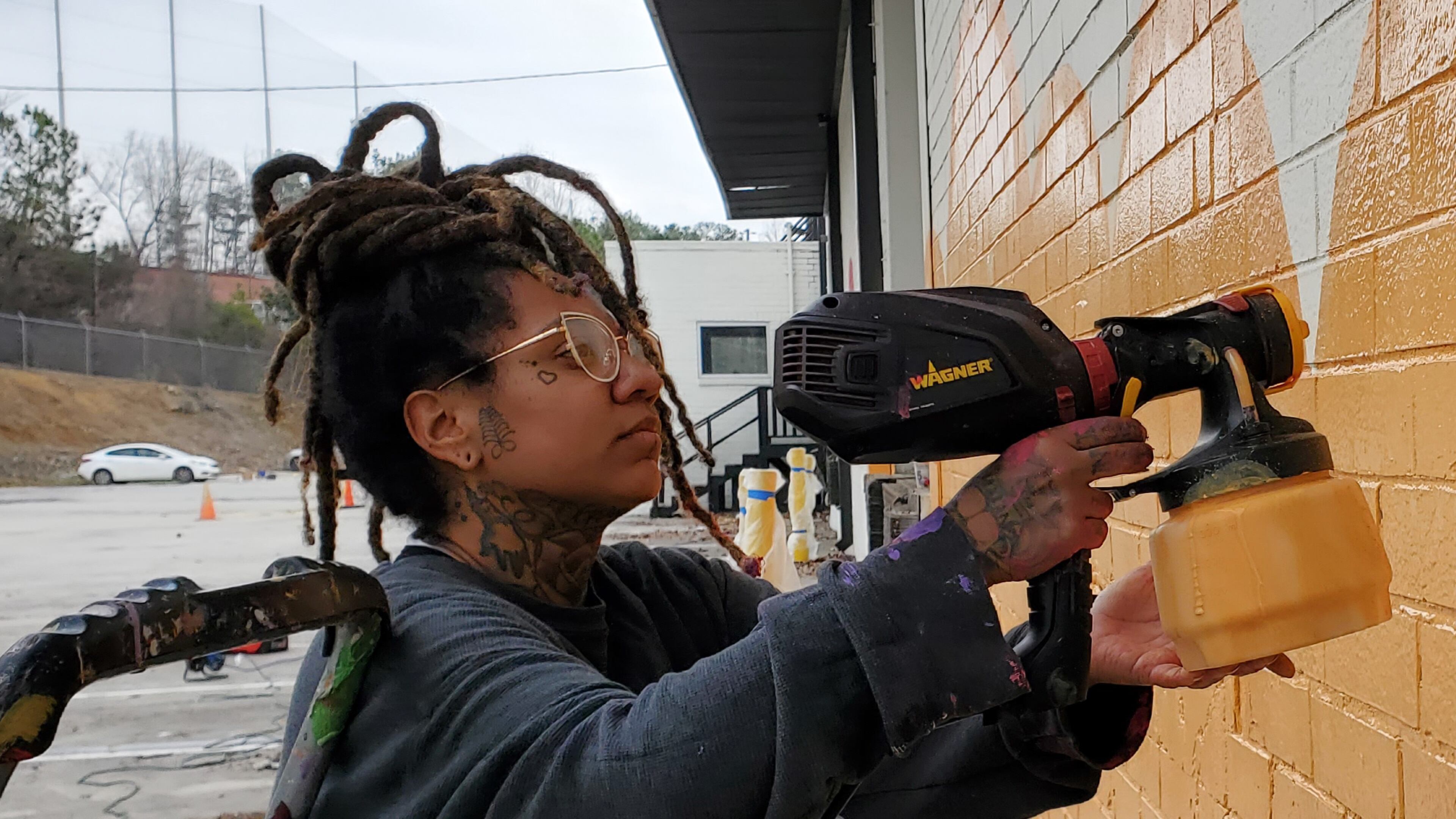 Charity Hamidullah works on one of her Atlanta murals. Photo: Arthur Rudick/Streetartmap.org
