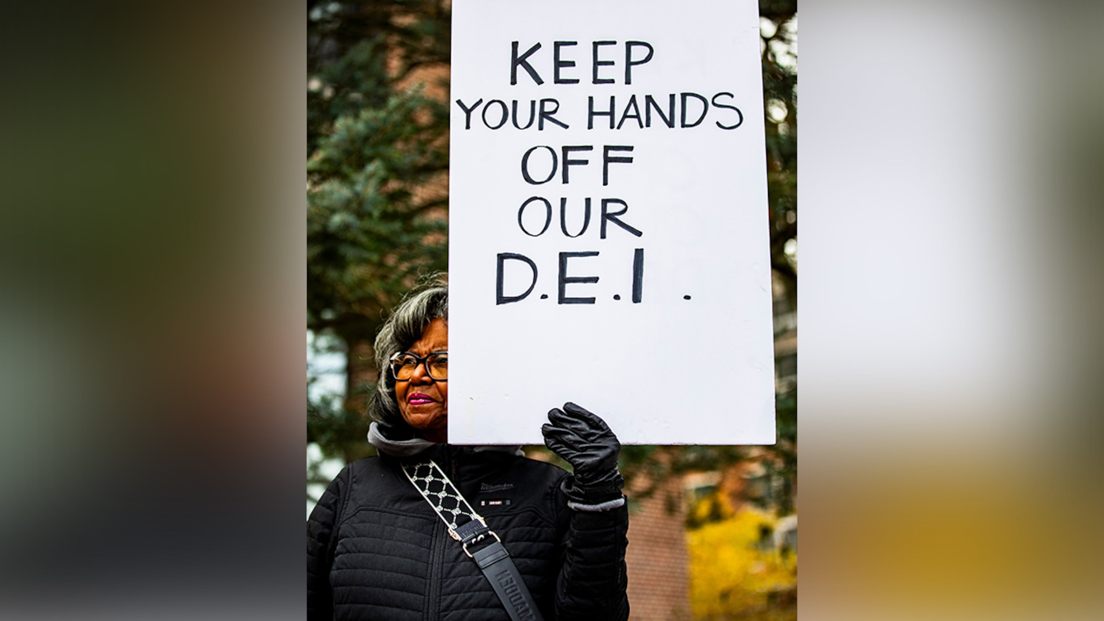A sign is held up during a rally to protect funding for Diversity Equity and Inclusion at the University of Michigan in Ann Arbor, Mich., Dec. 2, 2024. (Emily Elconin/The New York Times)