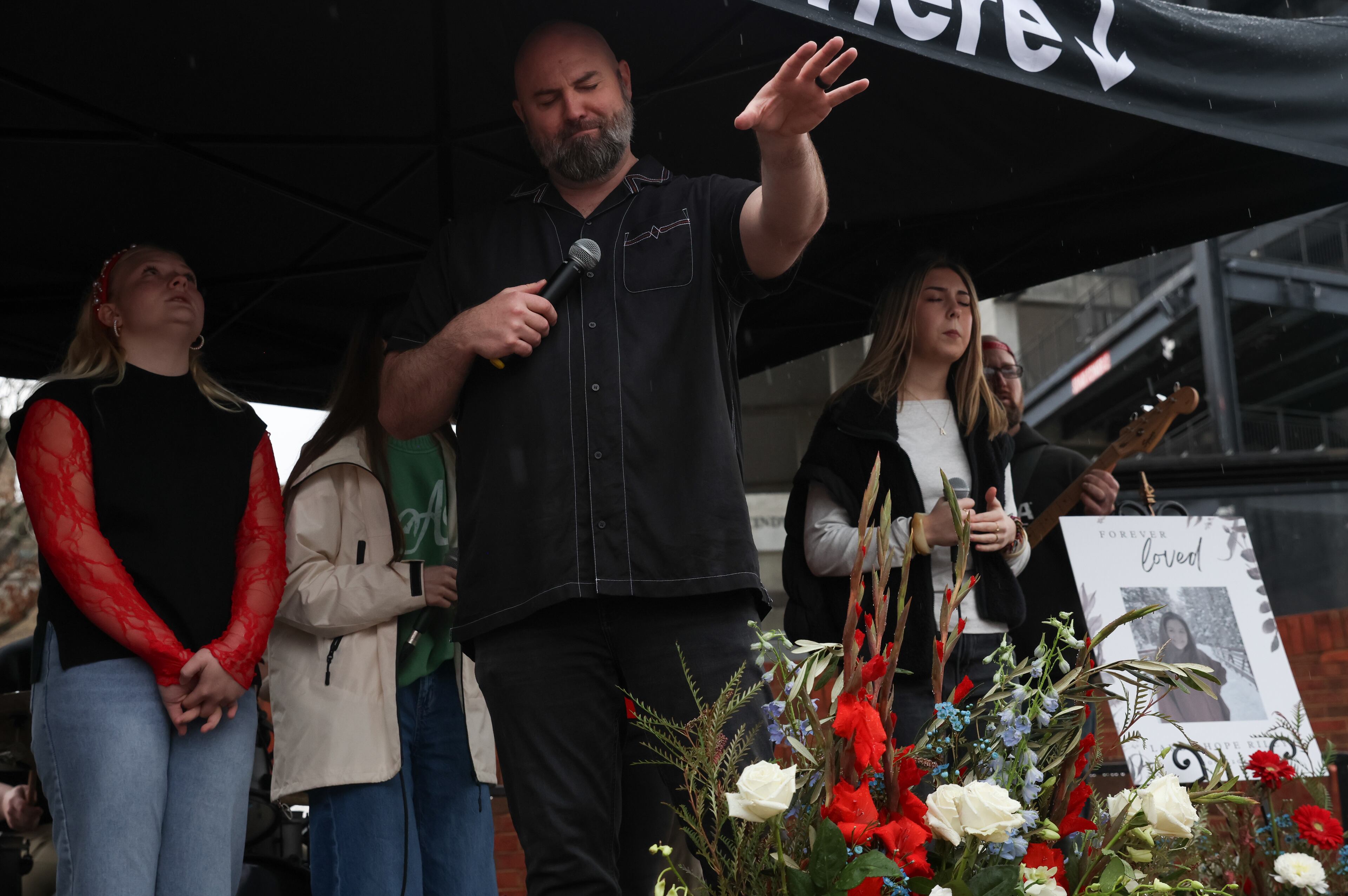 Derek Anglin, lead pastor of NewGrace Church in Commerce, presides over a worship service at UGA’s Tate Plaza on Saturday, Feb. 21, 2026, during a memorial for Augusta University nursing student Laken Riley. Riley was attacked and killed while running on the UGA campus in February 2024. Anglin’s sermon “Run for Your Life” inspired the memorial event’s title. (C.J. Bartunek for the AJC)