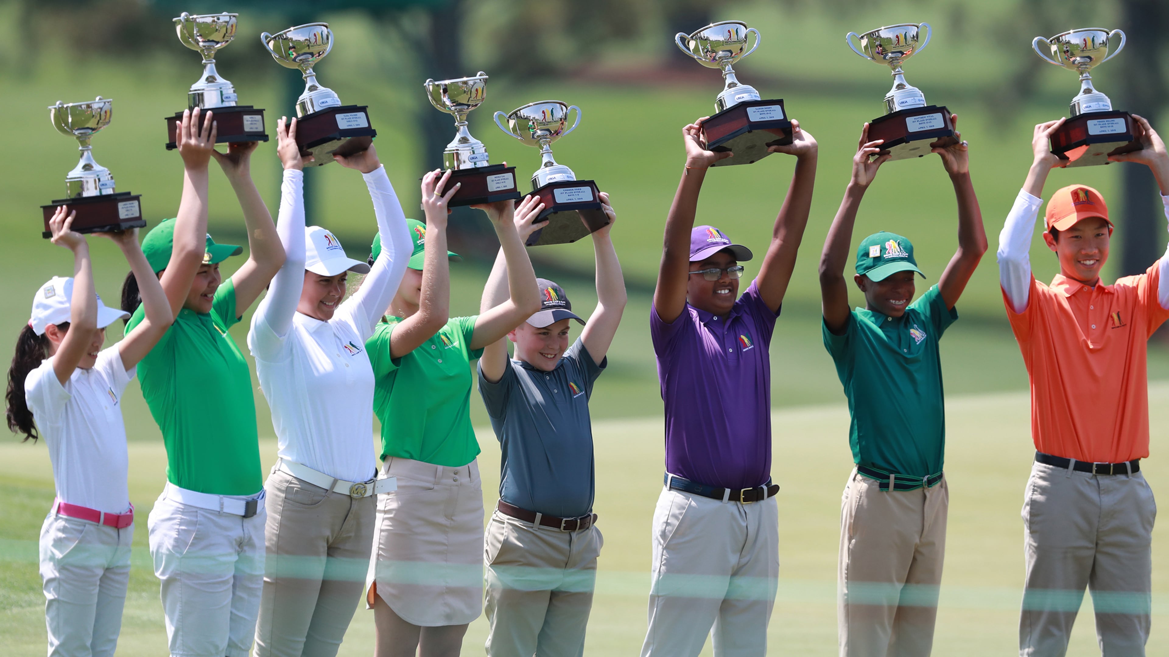Overall champions in the Drive, Chip, and Putt Championship at Augusta National Golf Club, including Sahish Reddy (third from right), of Duluth, hoist their trophies on Sunday, April 7, 2019, in Augusta.