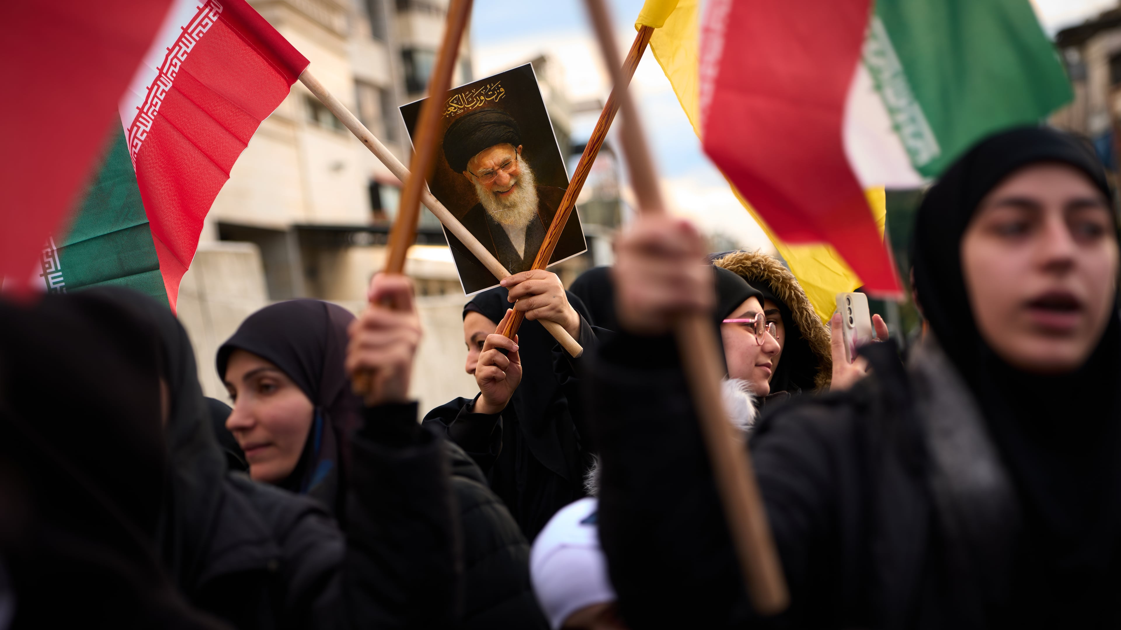 A woman holds a portrait of Iran's late Supreme Leader Ayatollah Ali Khamenei during a protest outside Iran's embassy, where dozens of people gathered waving Hezbollah and Iranian flags in solidarity with the Islamic Republic, in Beirut, Lebanon, Thursday, March 26, 2026. (AP Photo/Emilio Morenatti)