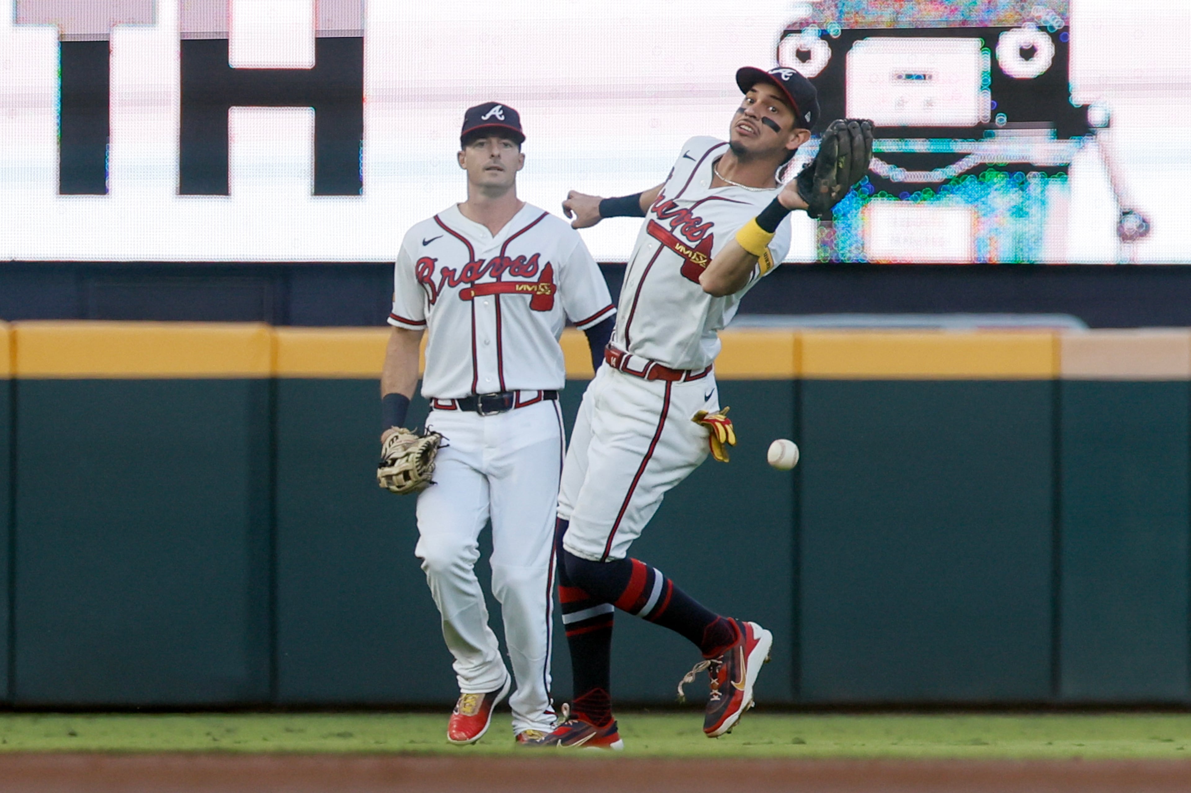 Atlanta Braves shortstop Mauricio Dubon (14) misses catching a shallow fly ball hit by Los Angeles Dodgers' Max Muncy, allowing a run to score, during the second inning of Game 4 of the MLB National League Division Series between the Atlanta Braves and the Los Angeles Dodgers, Wednesday, Oct. 7, 2026, in Atlanta. (Miguel Martinez/AJC)