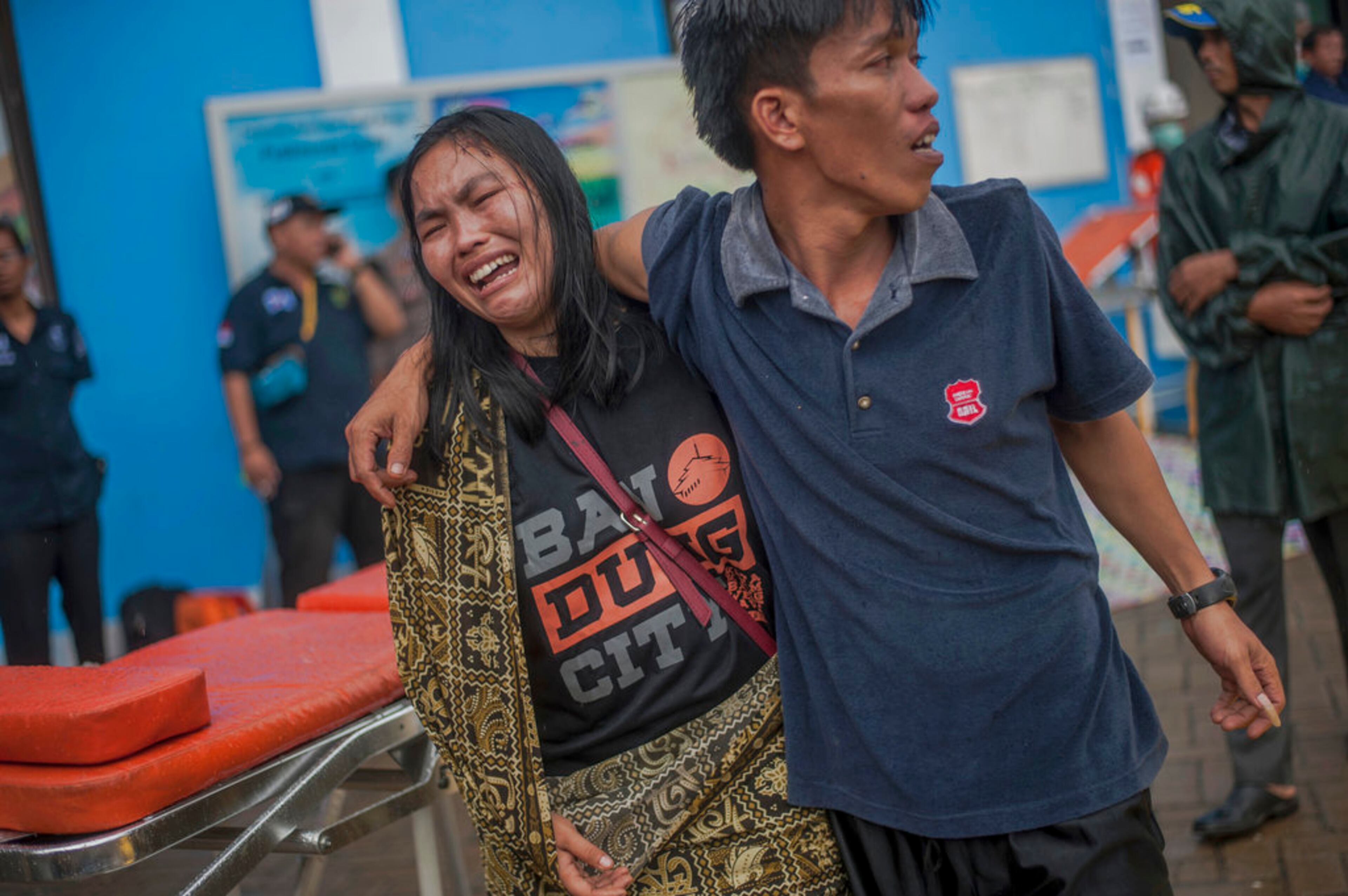 A woman reacts after identifying a relative among the bodies of tsunami victims in Carita, Indonesia, Sunday, Dec. 23, 2018. The tsunami occurred after the eruption of a volcano around Indonesia's Sunda Strait during a busy holiday weekend, sending water crashing ashore and sweeping away hotels, hundreds of houses and people attending a beach concert. (AP Photo/Fauzy Chaniago)