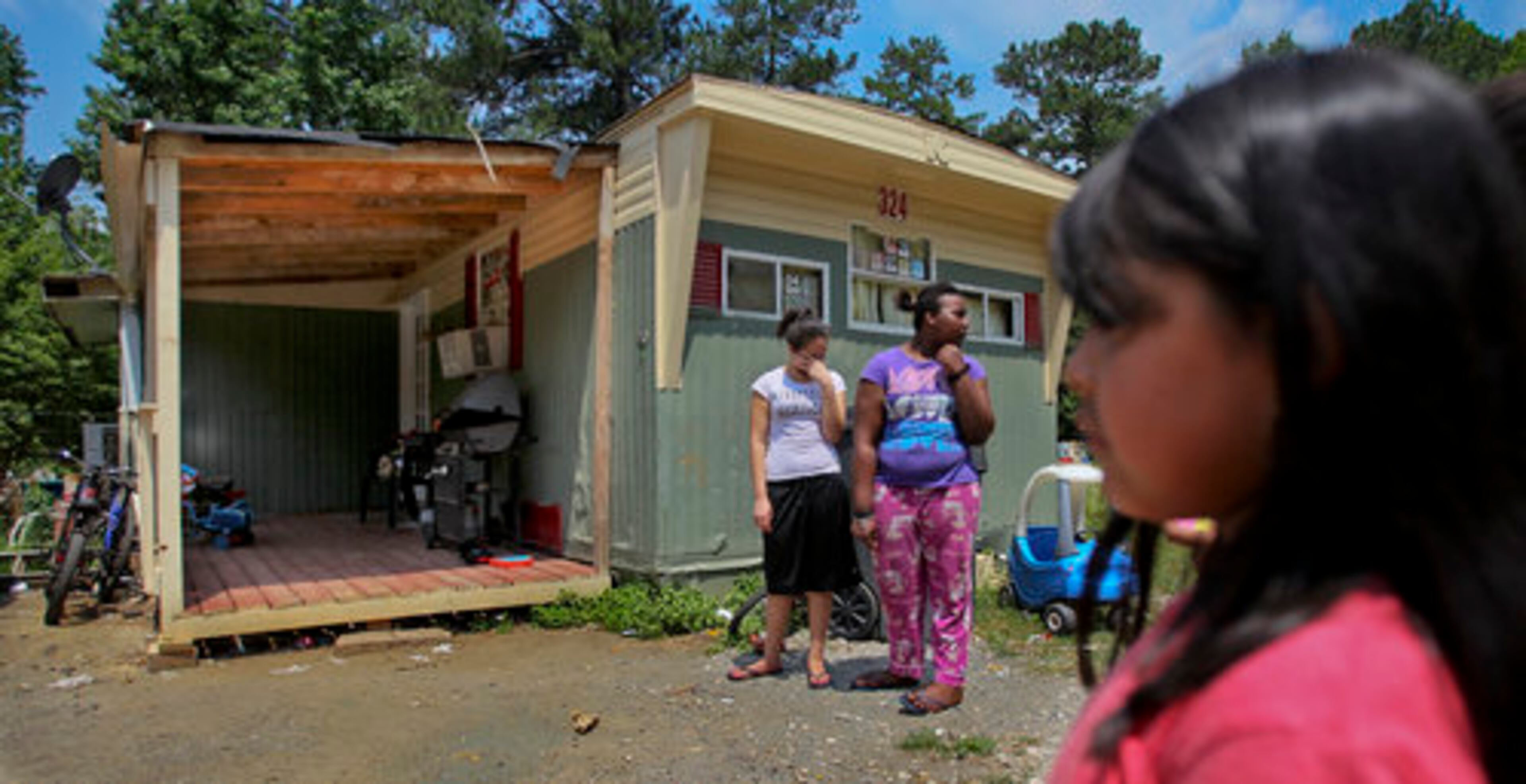 Yasmine Solis (left) and Emoni Jones (center) mourn the death of their friend, Javier. Oscar Mondragon has been charged with felony murder, aggravated assault and possession of a firearm by a minor.
