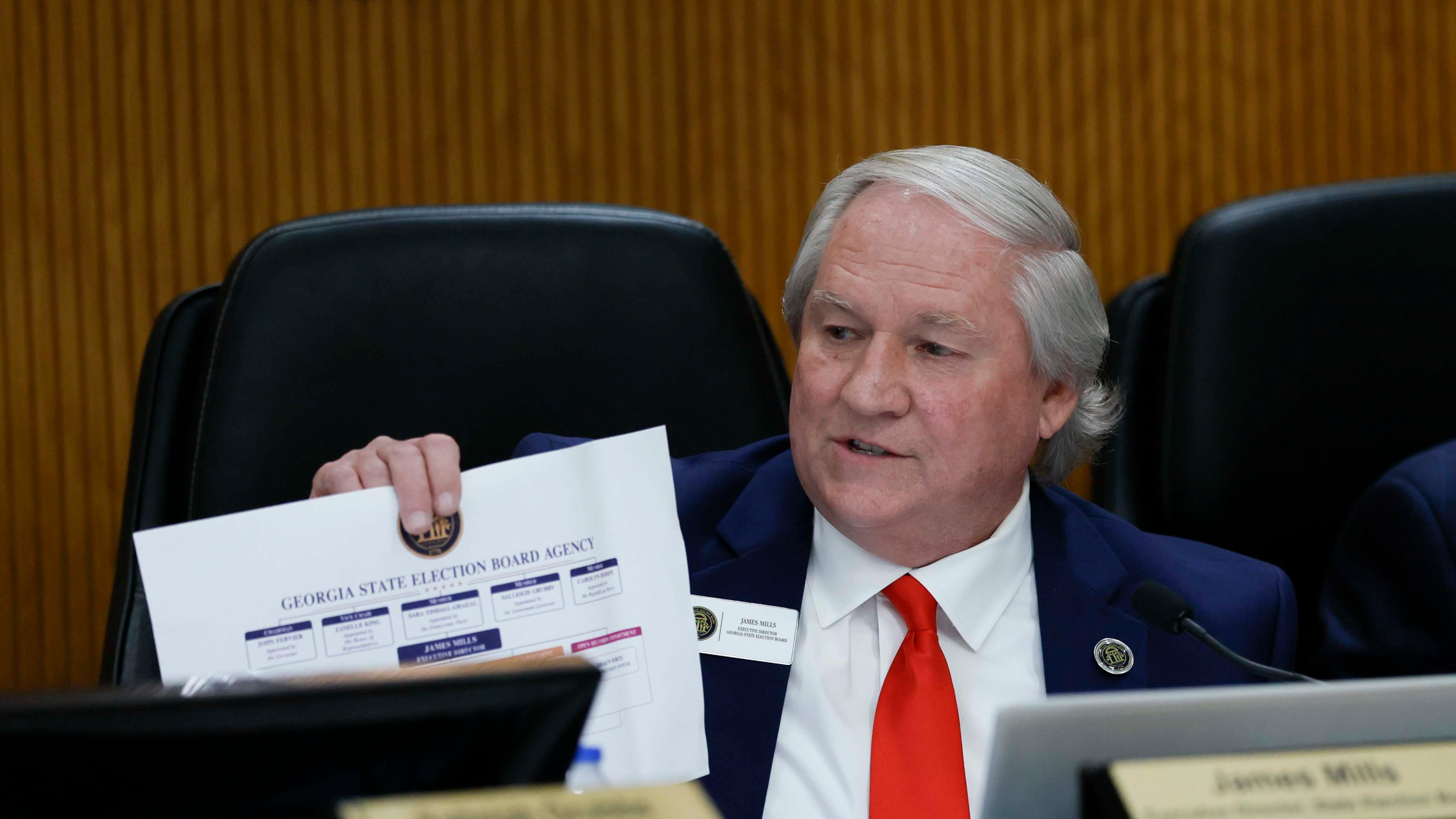 Executive Director of the State Elections Board, James Mills, displays a document during the State Elections Board meeting at the Fayette County Administration Complex on Wednesday, August 19, 2026. (Miguel Martinez/AJC)