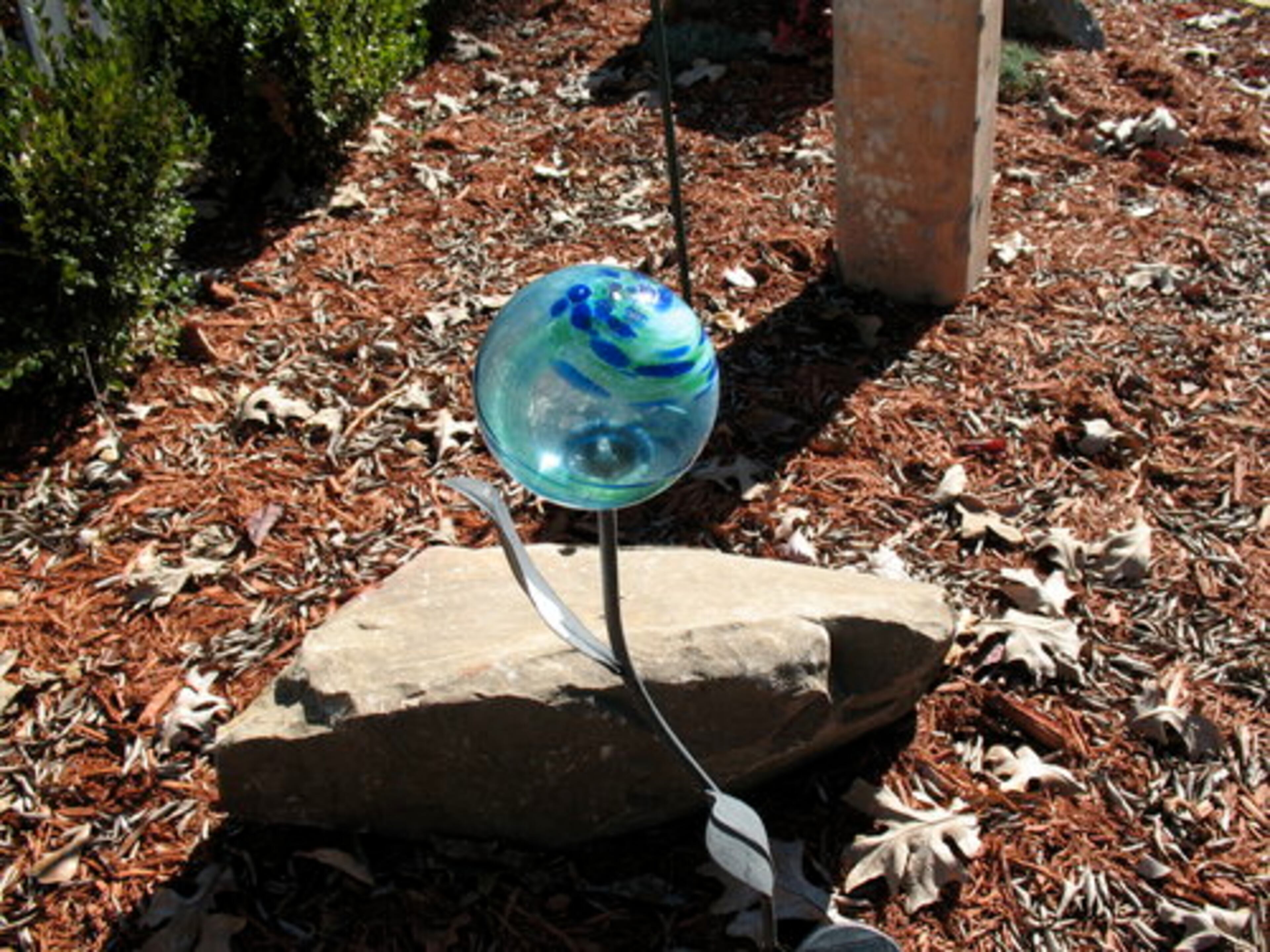 A trinket in the garden area. The couple's efforts included a transformation of the front yard that turned it into a formal garden with a slate path, boxwood hedges and potted plants inside a white fence.