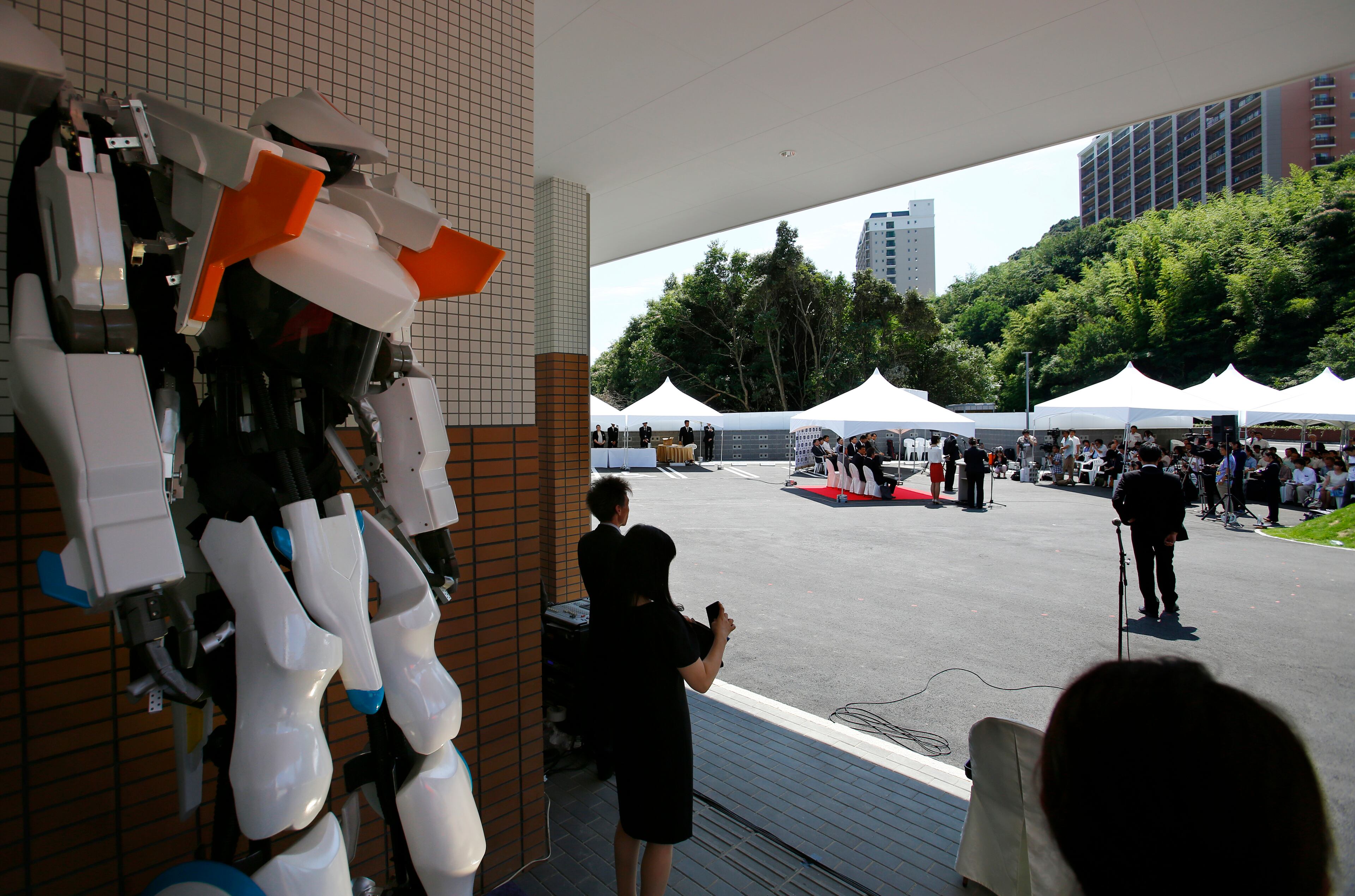 A robot stands by during an opening ceremony of the robot hotel, aptly called Henn na Hotel or Weird Hotel, in Sasebo, southwestern Japan, Wednesday, July 15, 2015. From the receptionist that does the check-in and check-out to the porter that's a stand-on-wheels taking luggage up to the room, the hotel is "manned" almost totally by robots to save labor costs. (AP Photo/Shizuo Kambayashi)