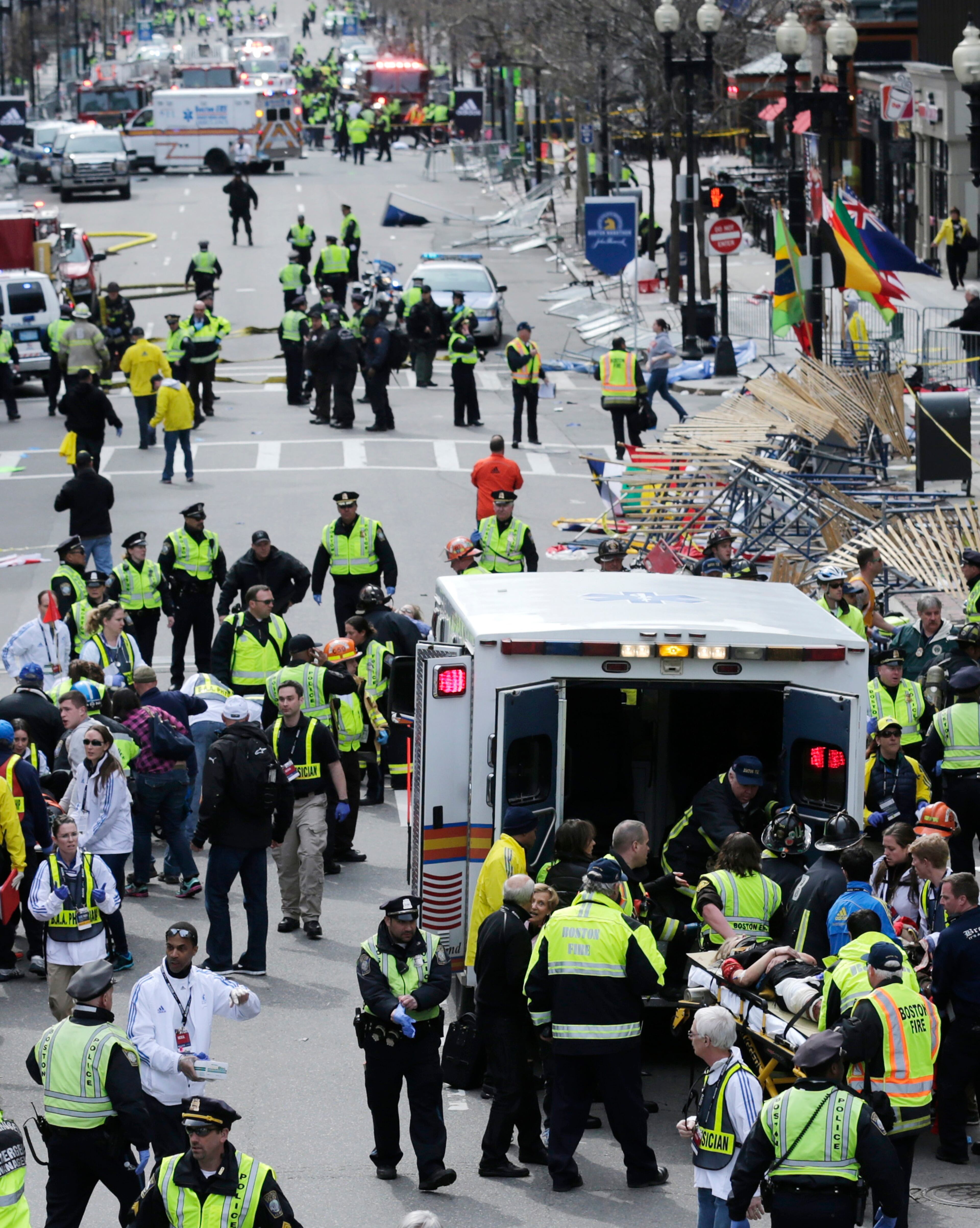 Medical workers aid injured people at the finish line of the 2013 Boston Marathon following an explosion on April 15, 2013. Two explosions shattered the euphoria of the Boston Marathon finish line, sending authorities out on the course to carry off the injured while the stragglers were rerouted away from the smoking site of the blasts.