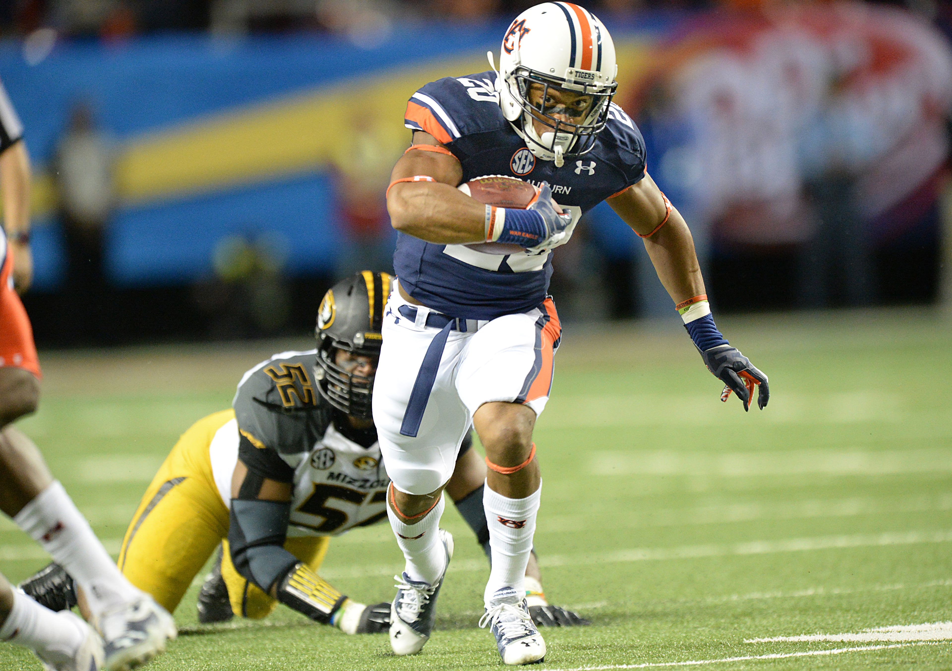 Auburn Tigers running back Corey Grant (20) runs past Missouri's Michael Sam on Saturday, December 7, 2013.