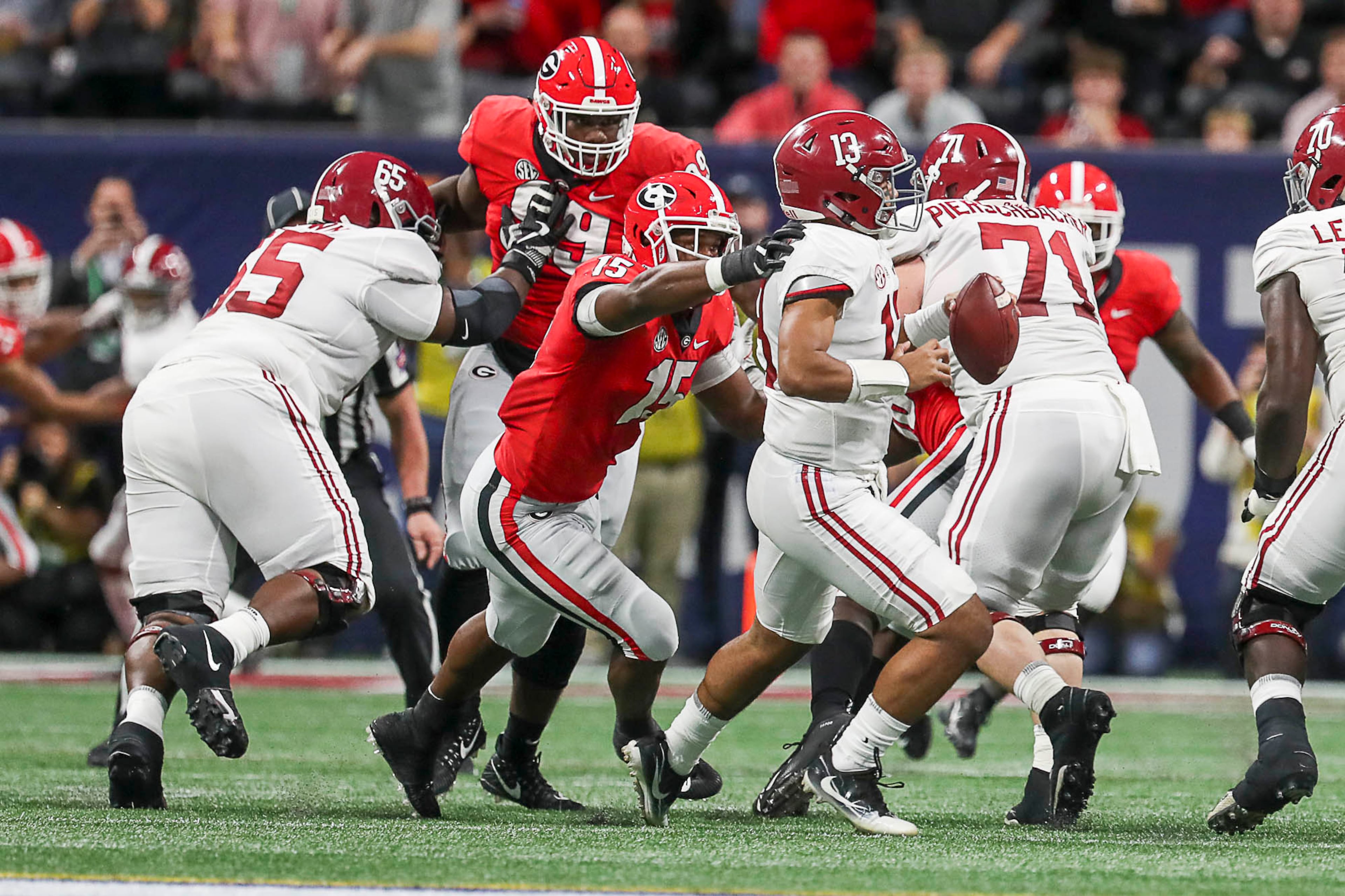 12/01/2018 -- Atlanta, Georgia -- Alabama Crimson Tide quarterback Tua Tagovailoa (13) is sacked during the first half of the SEC Championship game at Mercedes-Benz Stadium in Atlanta, Saturday, December 1, 2018. (ALYSSA POINTER/ALYSSA.POINTER@AJC.COM)