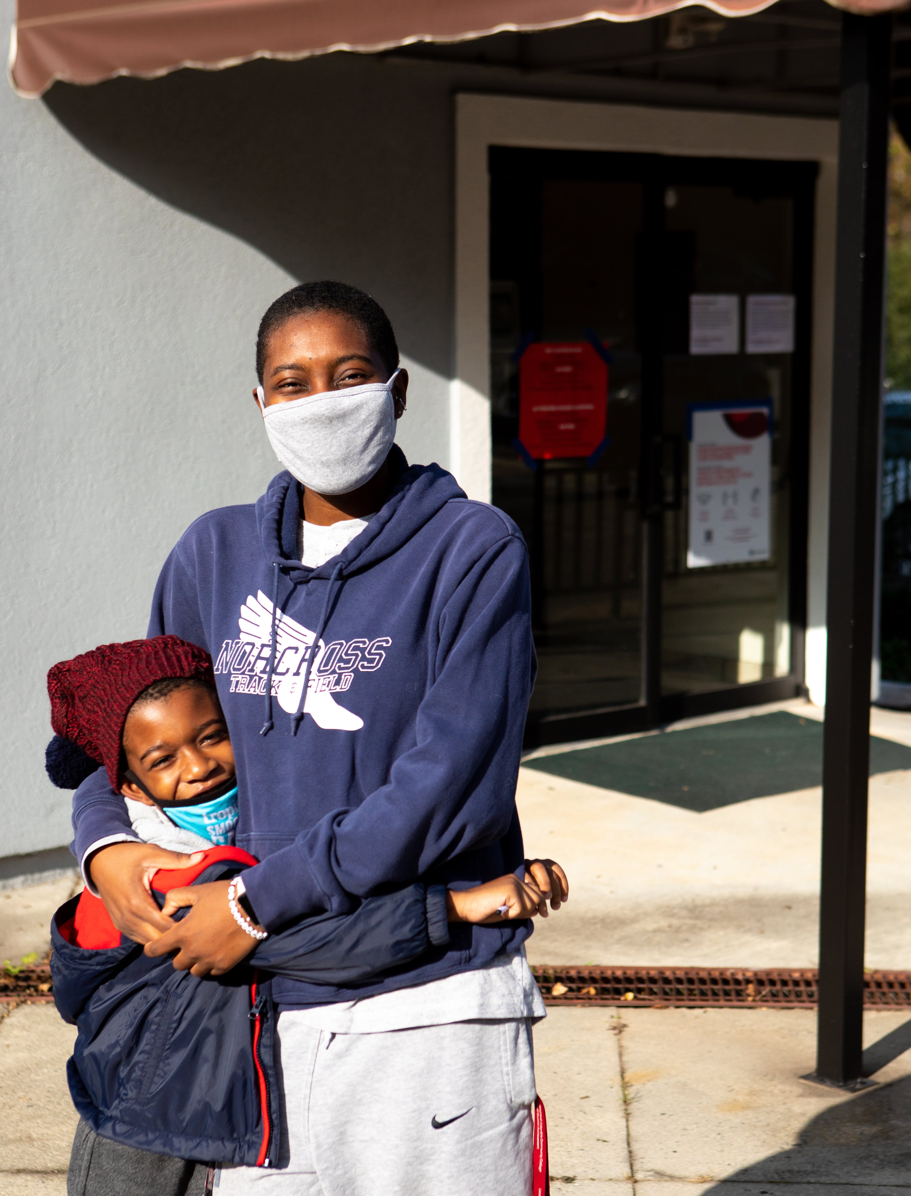 Grant O., 7, and his mom, Alia O., 26, pose together for a portrait after voting at Landmark Church in Peachtree Corners, Ga., on Tuesday, Nov. 3, 2020. "It's actually his second time voting, says Alia. "I wanted him to know the importance of voicing your opinion." (Casey Sykes for The Atlanta-Journal Constitution)