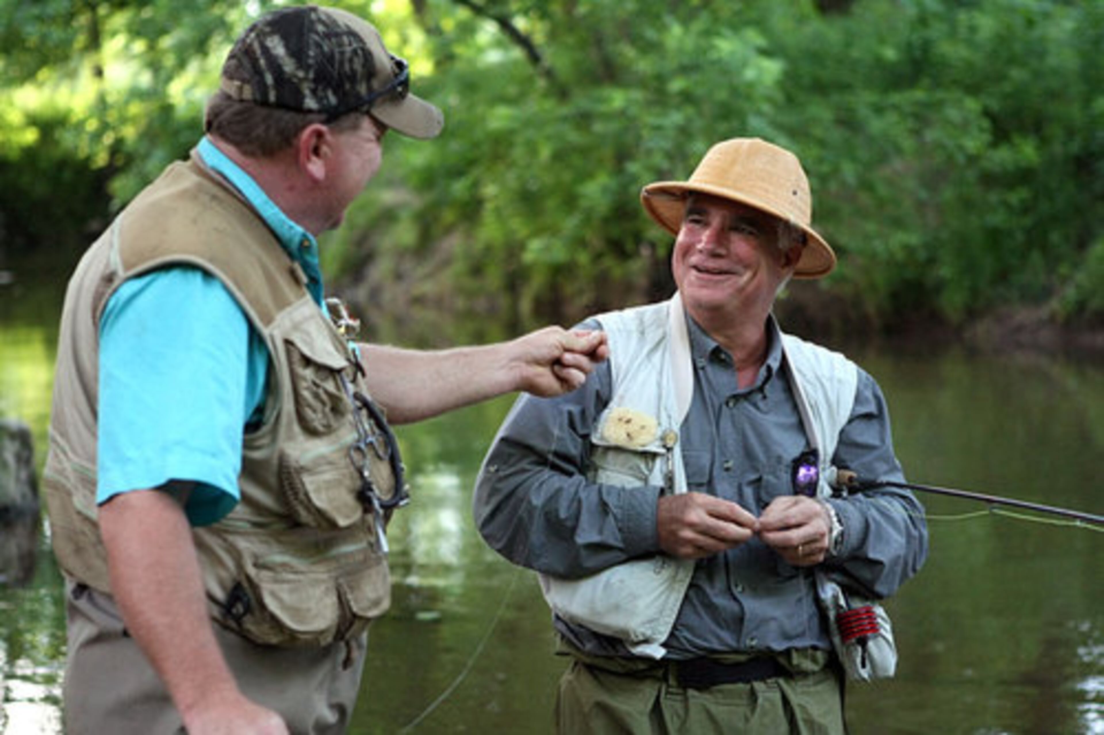 Smith shares a laugh with guide Eddie Michael, of North River Fly-fishing, on the Soque River in Clarkesville.