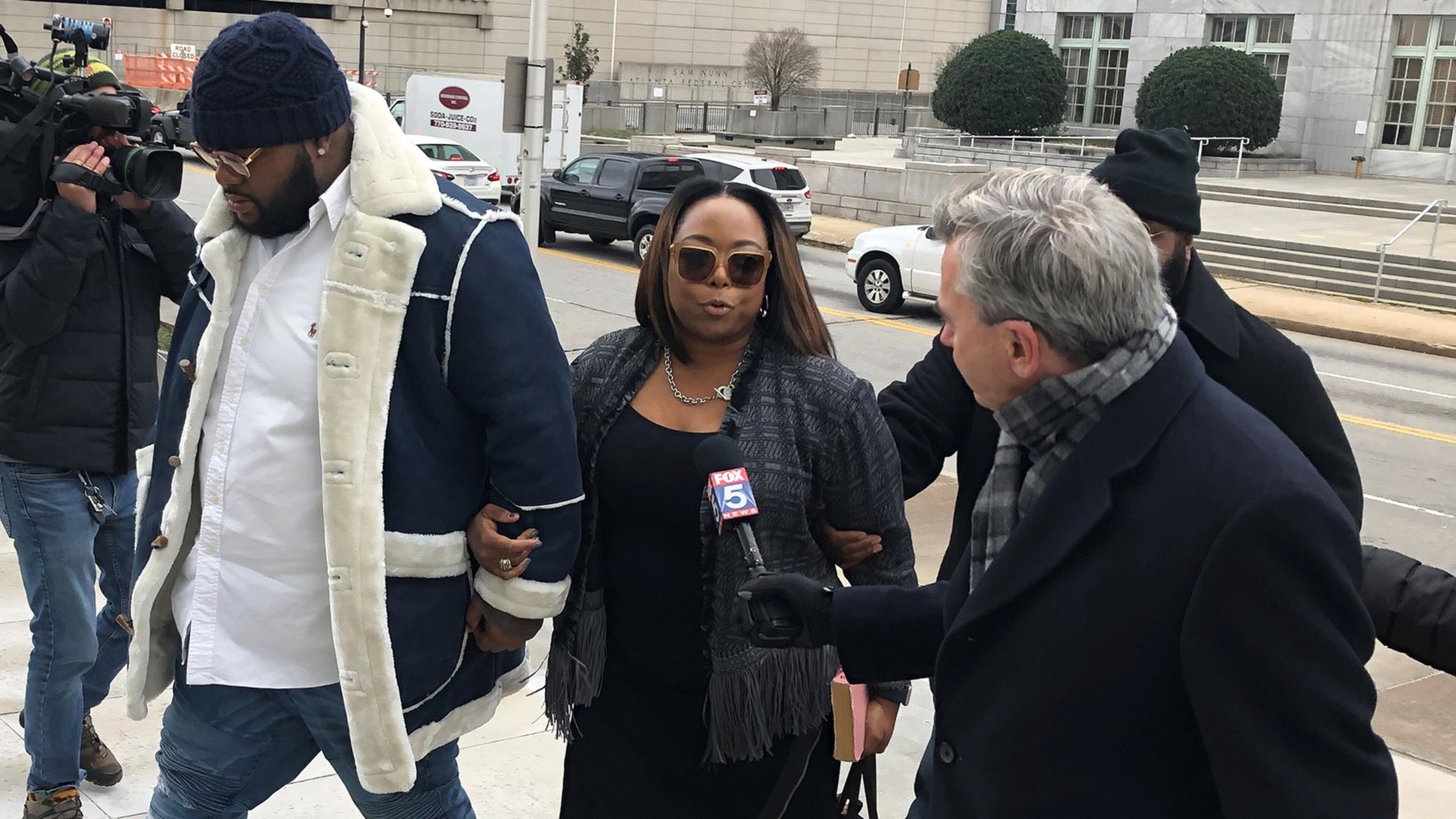 A former top aide to former Mayor Kasim Reed, Katrina Taylor-Parks (center), enters federal court in Atlanta Jan. 14. She pleaded guilty last year, admitting to taking bribes from a city vendor.