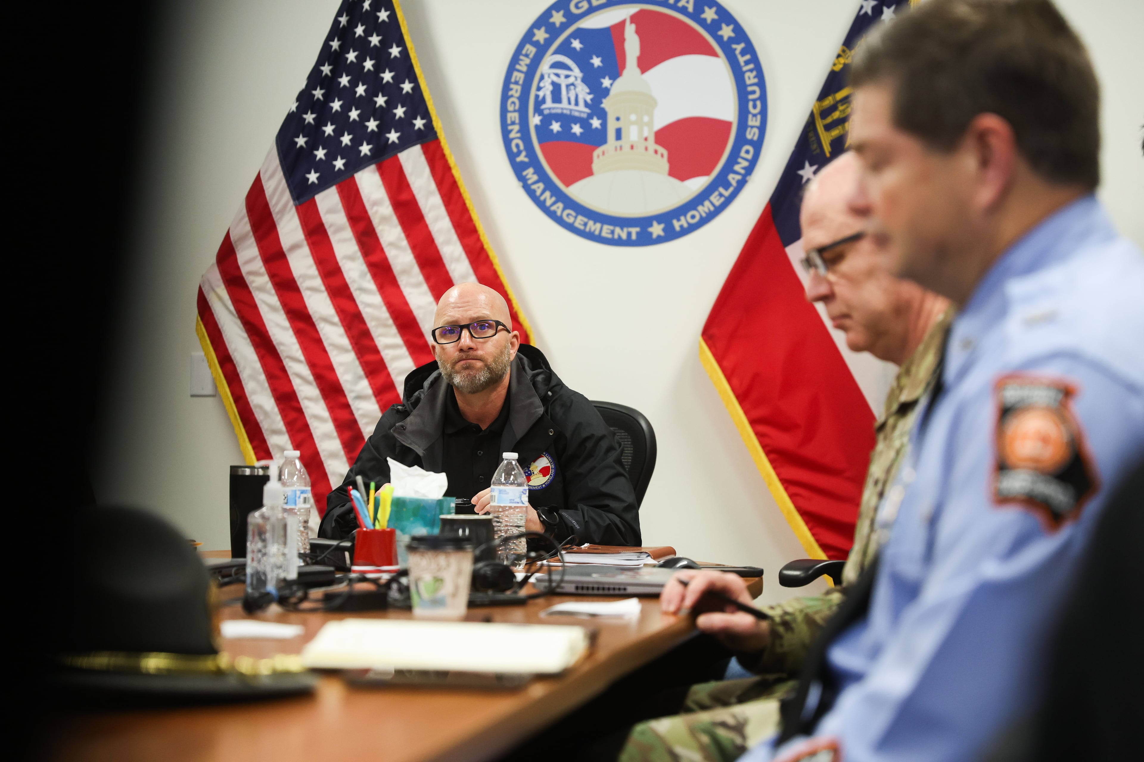 Director of the Georgia Emergency Management and Homeland Security Agency Josh Lamb listens to Gov. Brian Kemp during a briefing before a press conference at the GEMA State Operations Center in Atlanta on Saturday, Jan. 24, 2026. (Abbey Cutrer/AJC)