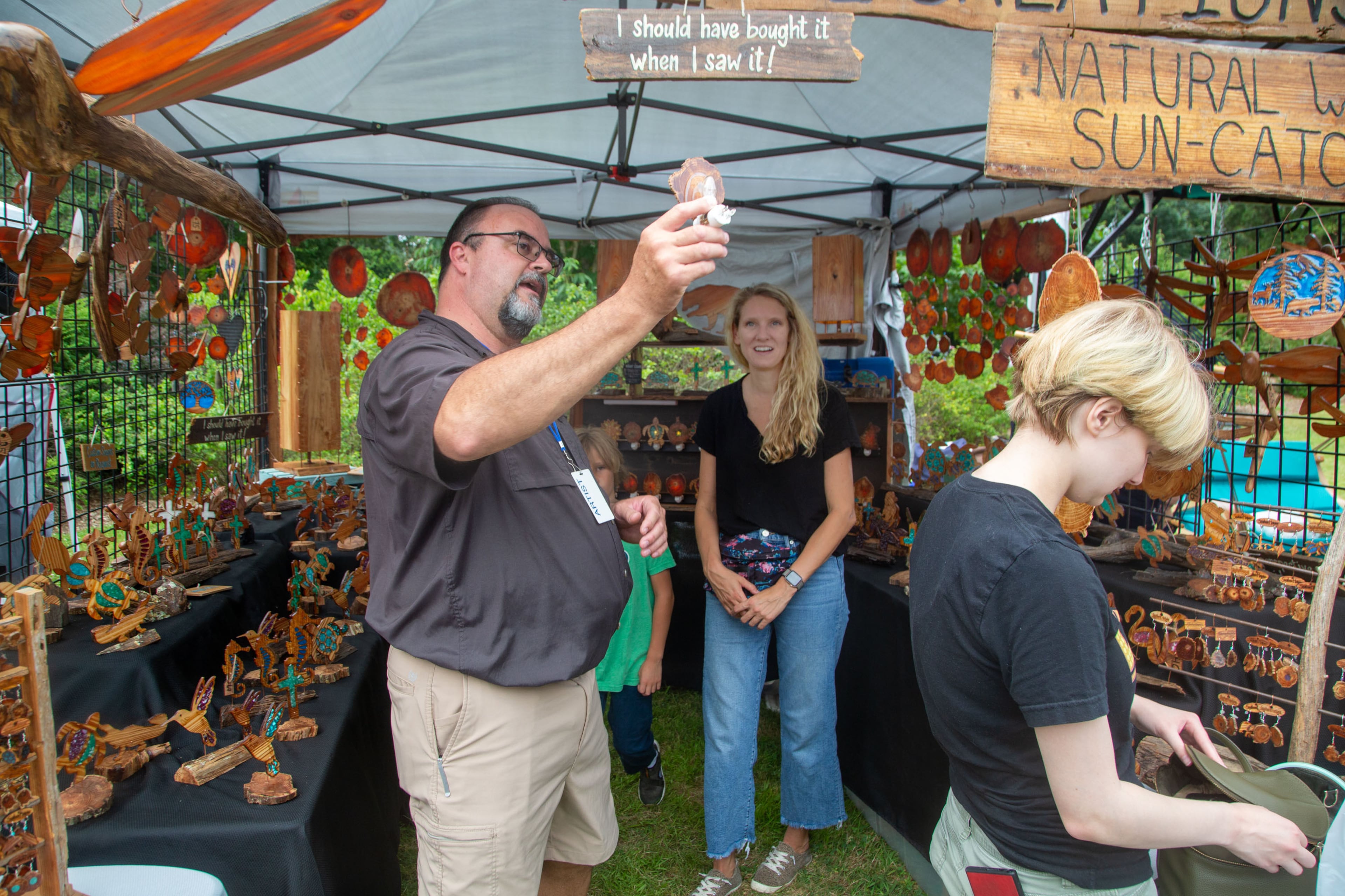 Ron Rummel shows off his translucent longleaf pine slices to a customer during the Festival on Ponce at Olmstead Linear Park in Atlanta on Sunday, June 6, 2021. (Photo: Steve Schaefer for The Atlanta Journal-Constitution)