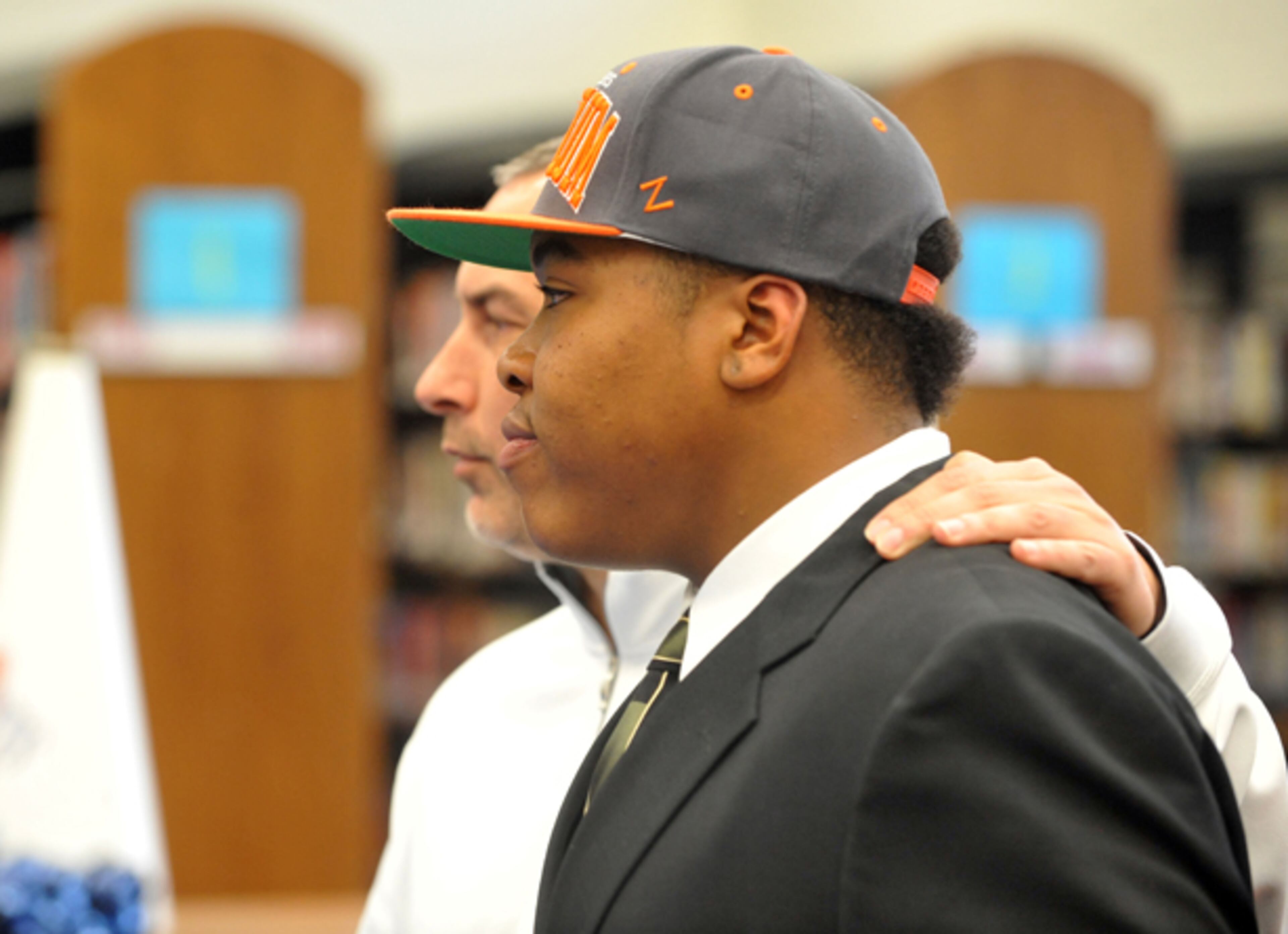 Spencer Roberts stands with head football coach Chip Walker before signing with Tusculum College on National Signing Day at Sandy Creek High School in Tyrone.
