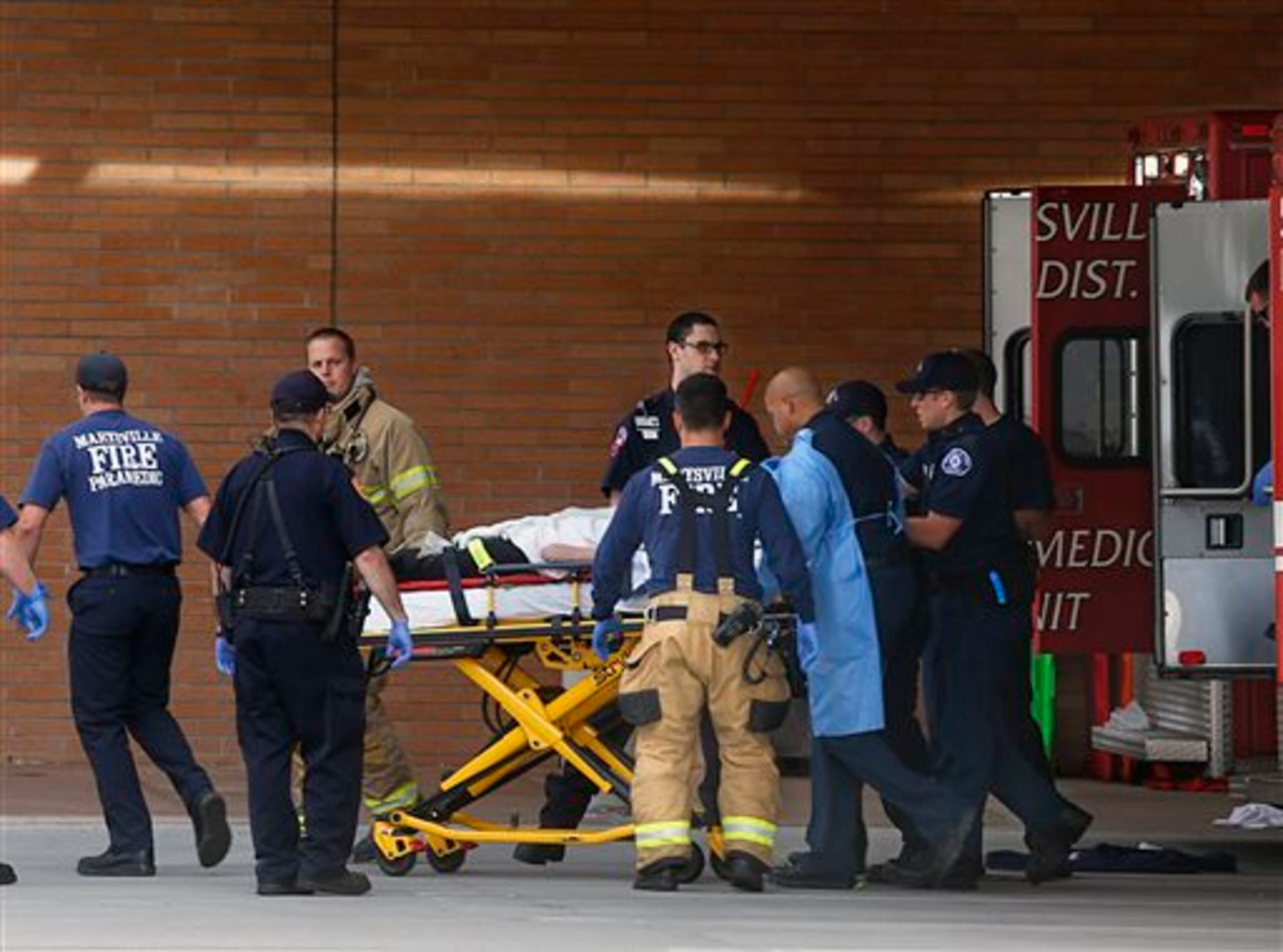 Firefighters, medics and hospital staff move one of the Marysville Pilchuck High School shooting victims from an ambulance into Providence Regional Medical Center in Everett, Friday, Oct. 24, 2014, following the shooting at the high school. A student walked into his Seattle-area high school cafeteria on Friday and opened fire without shouting or arguing, killing one person and shooting several others in the head before turning the gun on himself, officials and witnesses said. (AP Photo/The Herald, Dan Bates)