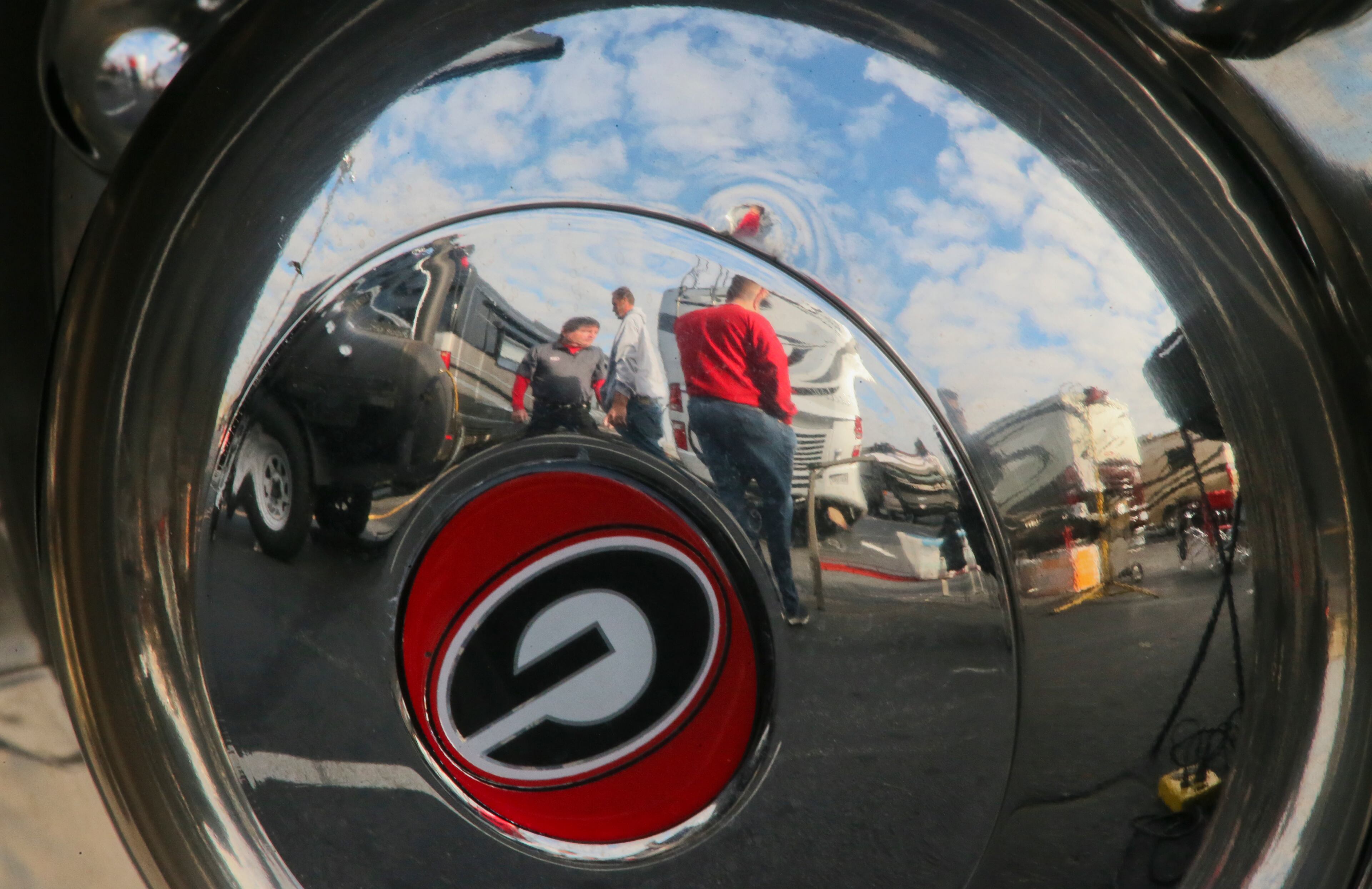 Georgia hubcaps reflect tailgaters setting up on Friday. | Tailgating at Dome has begun | Bulldogs fans excited | Complete SEC Championship coverage
