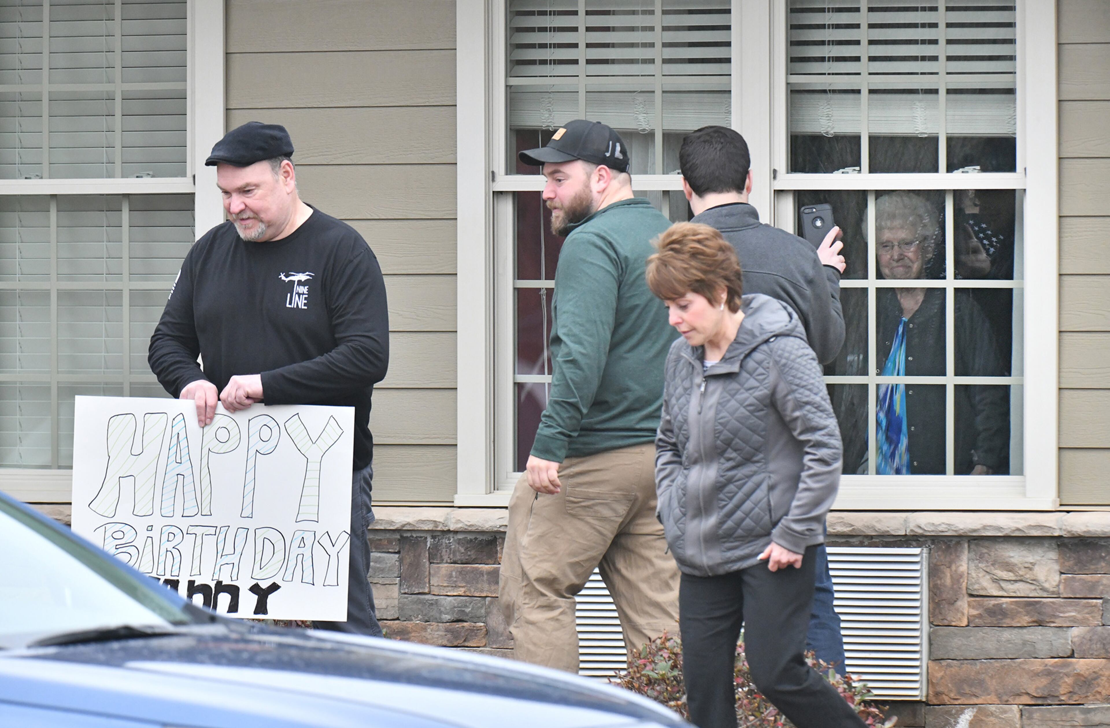 March17, 2020 Canton - Family members visit an elderly family member thru the window after they delivered a birthday balloon and a gift bag at The Retreat at Canton, where confirmed that three residents and an employee have "tested presumptively positive" for COVID-19, on Tuesday, March 17, 2020. The Retreat at Canton confirmed that three residents and an employee have "tested presumptively positive" for COVID-19, according to a release by the facility that has 90 beds. (Hyosub Shin / Hyosub.Shin@ajc.com)