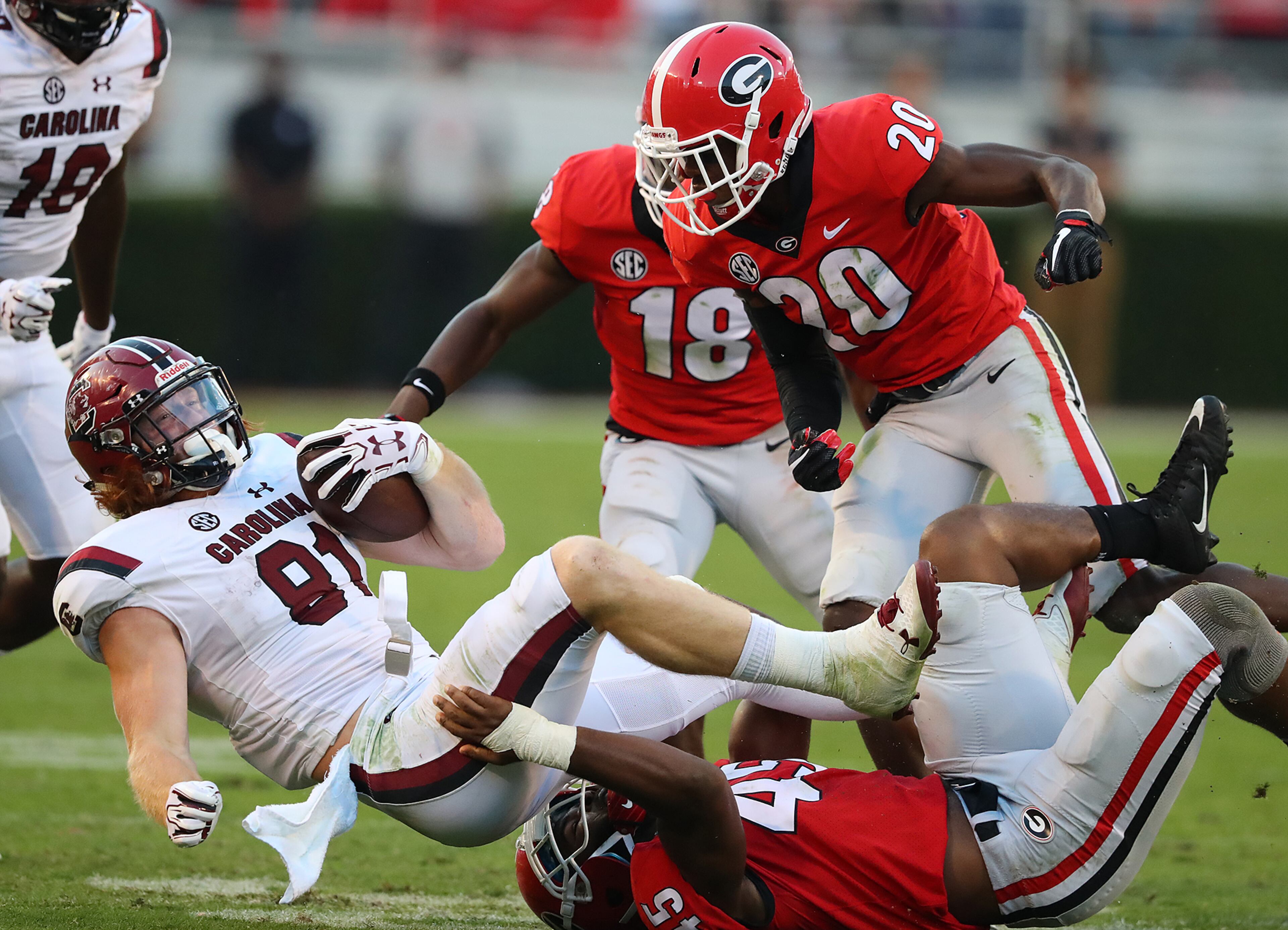 November 4, 2017 Athens: Georgia linebacker Reggie Carter tackles South Carolina tight end Hayden Hurst during the second half in a NCAA college football game on Saturday, November 4, 2017, in Athens. Curtis Compton/ccompton@ajc.com