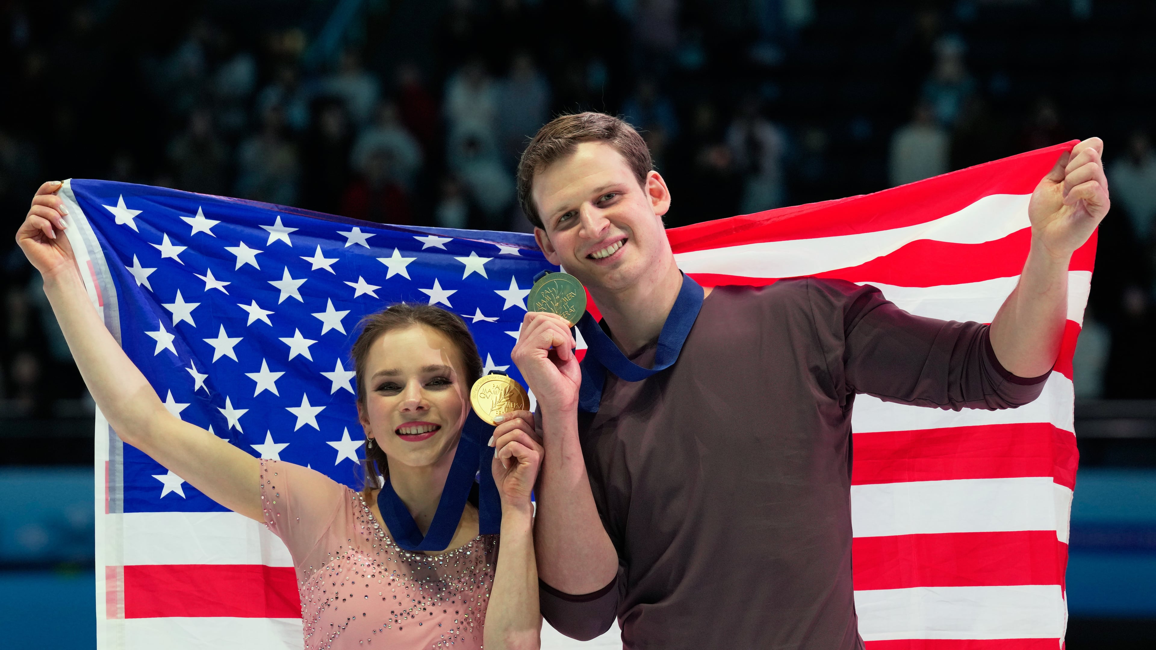Gold medalists Alisa Efimova and Misha Mitrofanov of the United States celebrate with their national flag and medals after the Pairs Free Skating of the ISU Four Continents Figure Skating Championships in Beijing, China, Saturday, Jan. 24, 2026. (AP Photo/Vincent Thian)